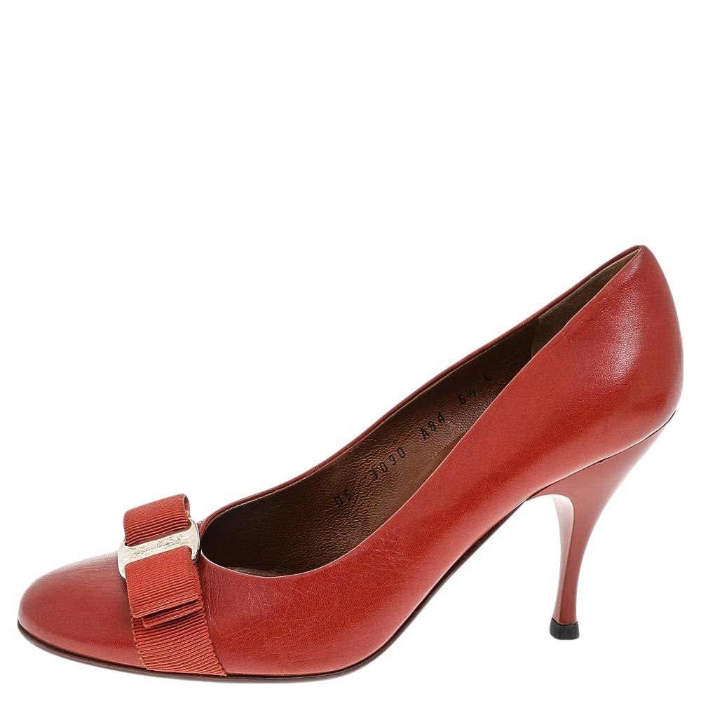 The Vara Bow collection from Salvatore Ferragamo certainly needs no introduction. These Vara Bow pumps are creatively made using rust-orange leather, with the signature bow accent perched on the front. Their shape is highlighted by silver-toned