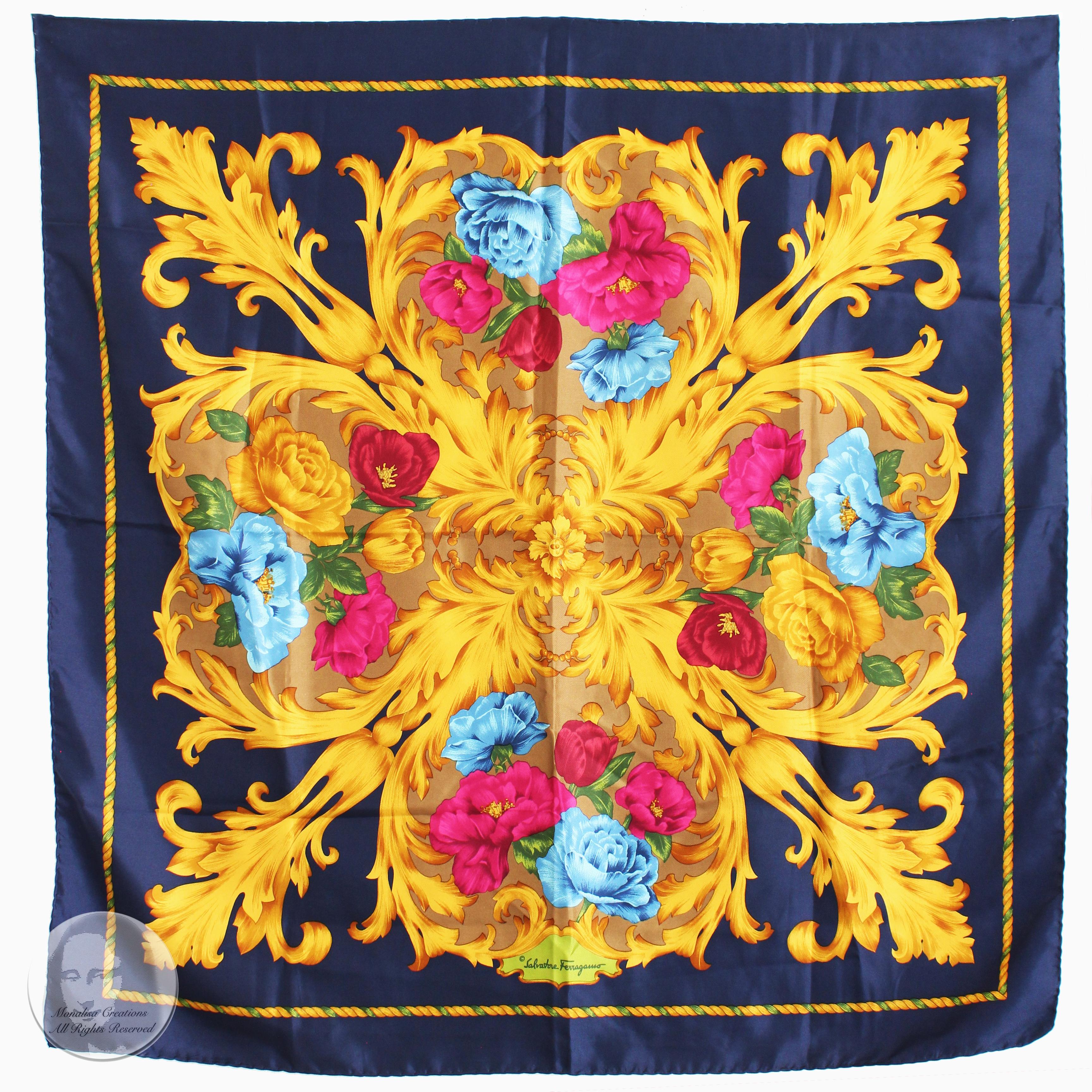 This silk scarf or shawl was made by Salvatore Ferragamo, most likely in the 90s. It features colorful pink, blue and red florals with gold baroque style stems against a navy blue background. 

A fabulous silk scarf that's so easy to style and wear!