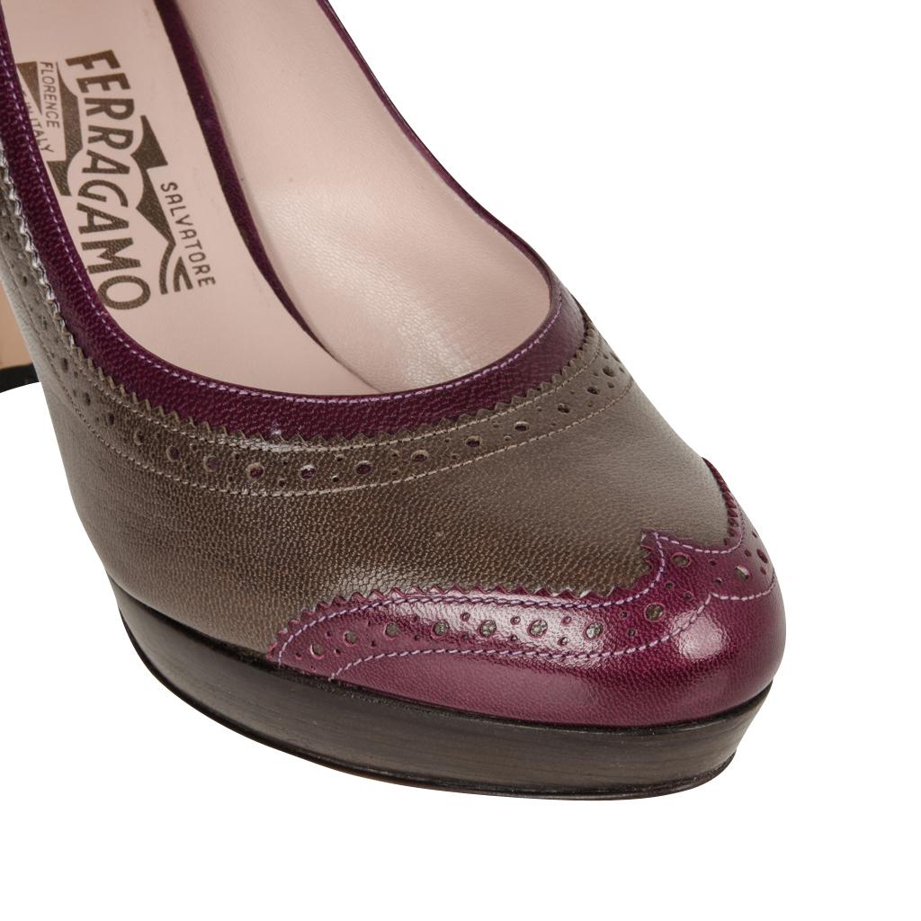 Guaranteed authenticSalvatore Ferragamo  two tone leather pump. 
Gorgeous medium gray with magenta detail platform shoe.
Wingtip detail edging around the foot and at the toe. 
Dark gray wood stacked heel.
Comes with box and sleepers.
NEW or NEVER