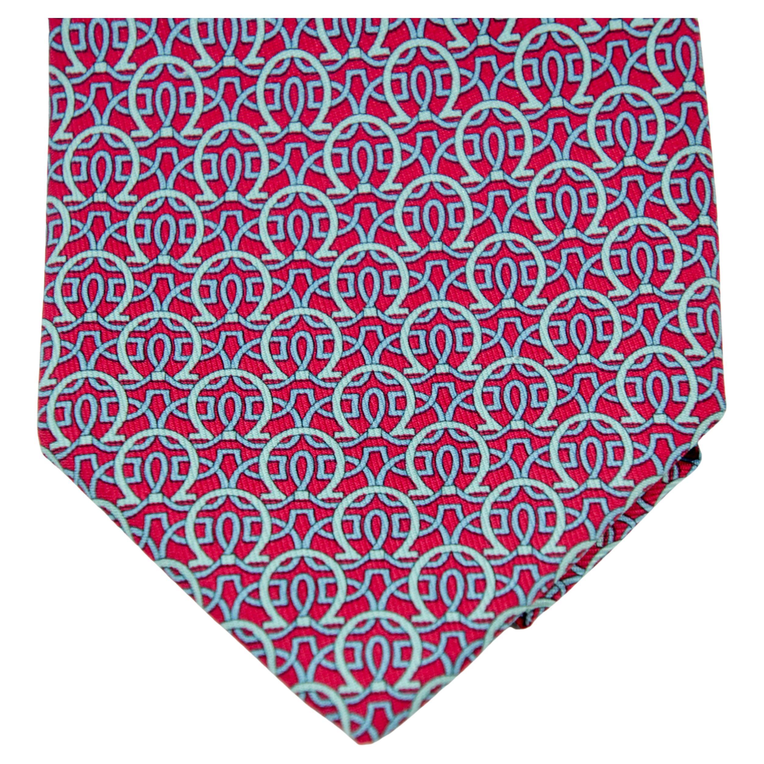 Vintage SALVATORE FERRAGAMO silk tie with contrasting-colored wavy pattern intermingles with the Gancini detailing to create a timeless tie. 
The refined hue in pink and blue ensures it can be paired with endless looks, from the most formal to