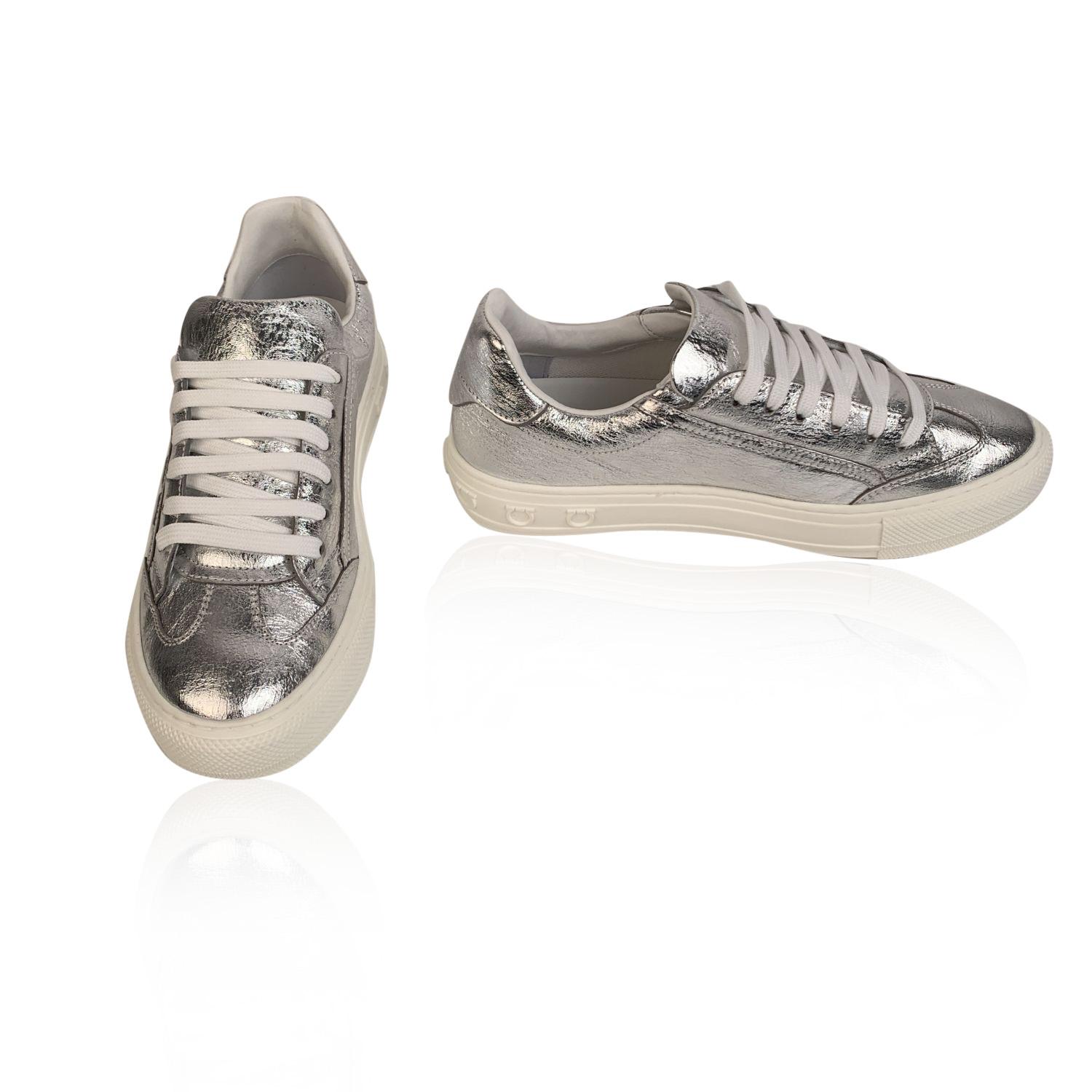 Beautiful Salvatore Ferragamo 'Borg' Sneakers. Silver tone leather. They feature a lace-up front, round toe and embossed logo on the side. Rubber sole. Made in Italy. Size: US 7 C - EU 37.5 (The size shown for this item is the size indicated by the