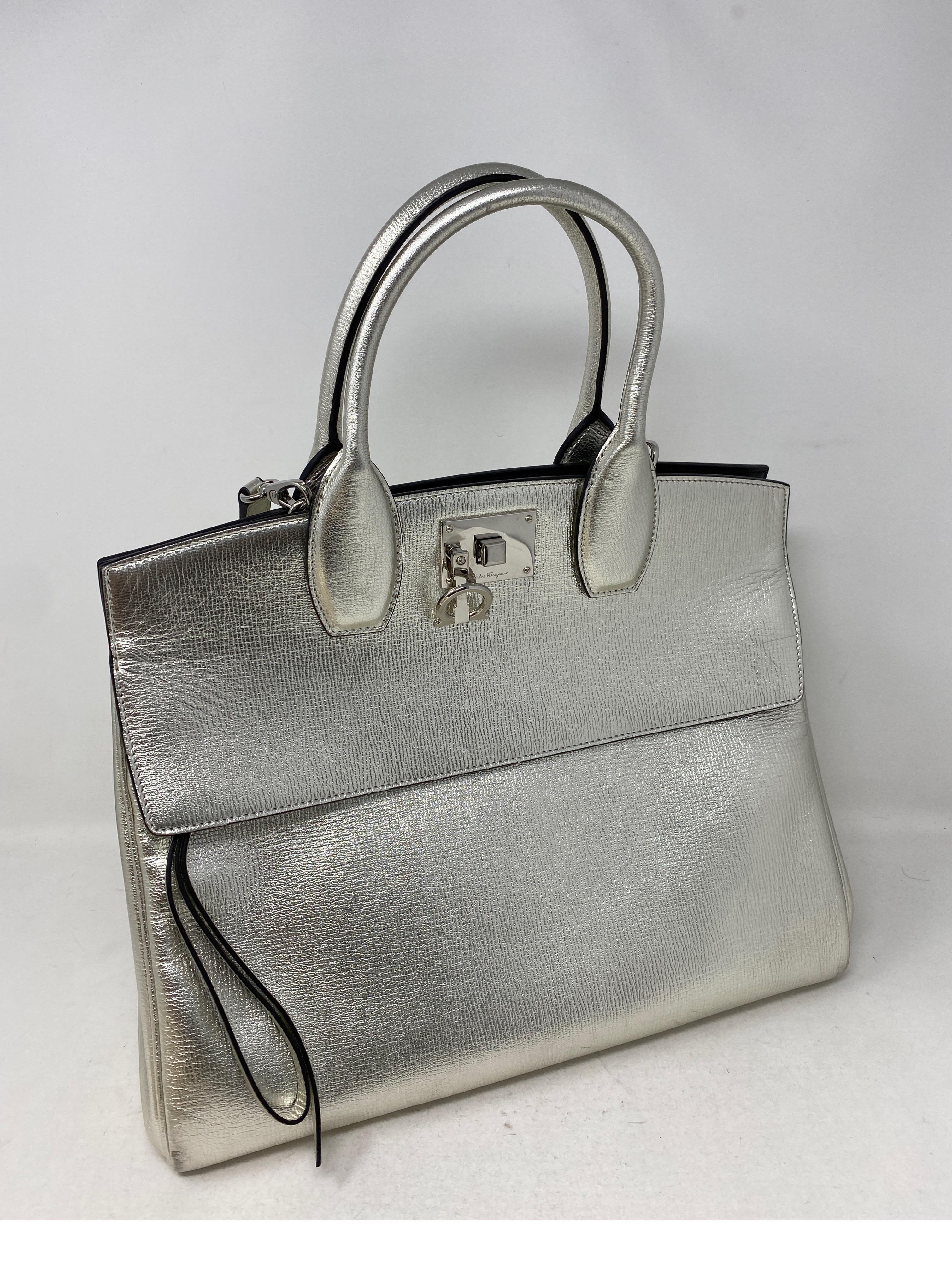 Salvatore Ferragamo Silver Leather Tote Bag. Includes silver leather strap. Excellent condition. All metallic silver leather. Black leather interior. Guaranteed authentic. 