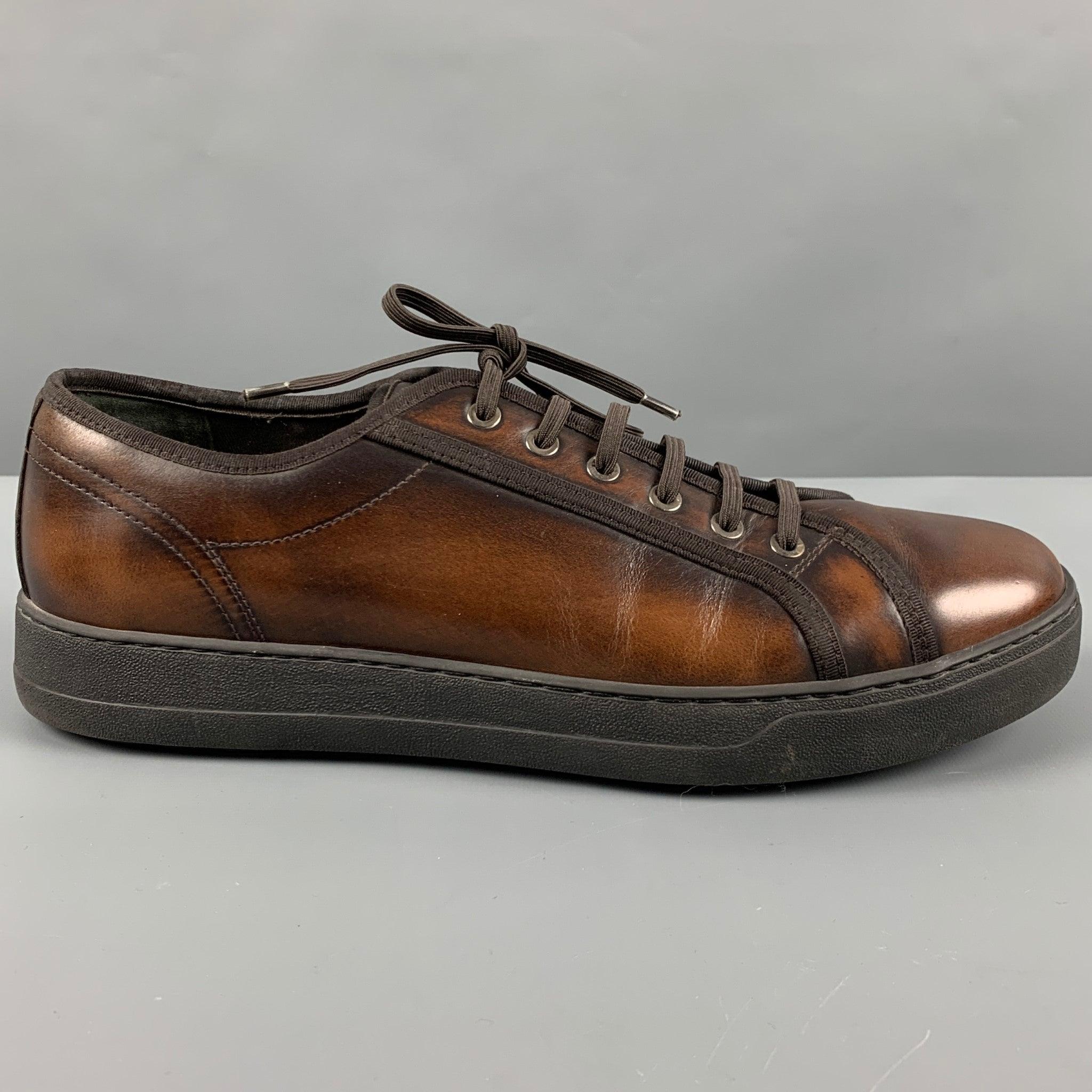 SALVATORE FERRAGAMO sneakers
in a brown leather fabric featuring burnished look, rubber sole, and lace-up closure. Made in Italy.Excellent Pre-Owned Condition. 

Marked:   TZ 41188 A16S 10 EEOutsole: 12 inches  x 4.25 inches 
  
  
 
Reference: