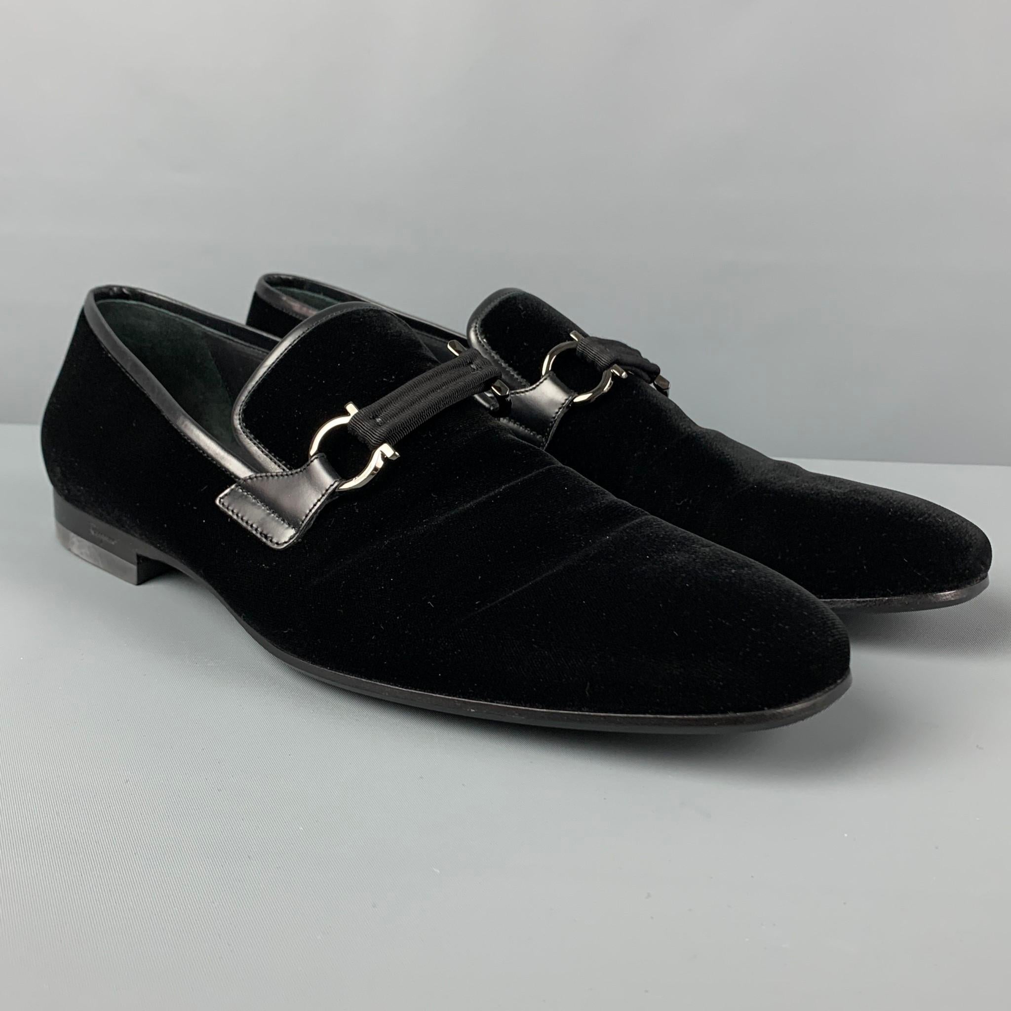 SALVATORE FERRAGAMO 'Lapo' loafers comes in a black velvet with a leather trim featuring a grosgrain strap with a gancino hardware, round toe, slip-on style, and a stacked heel. Includes box. Made in Italy. 

Very Good Pre-Owned Condition.
Marked: