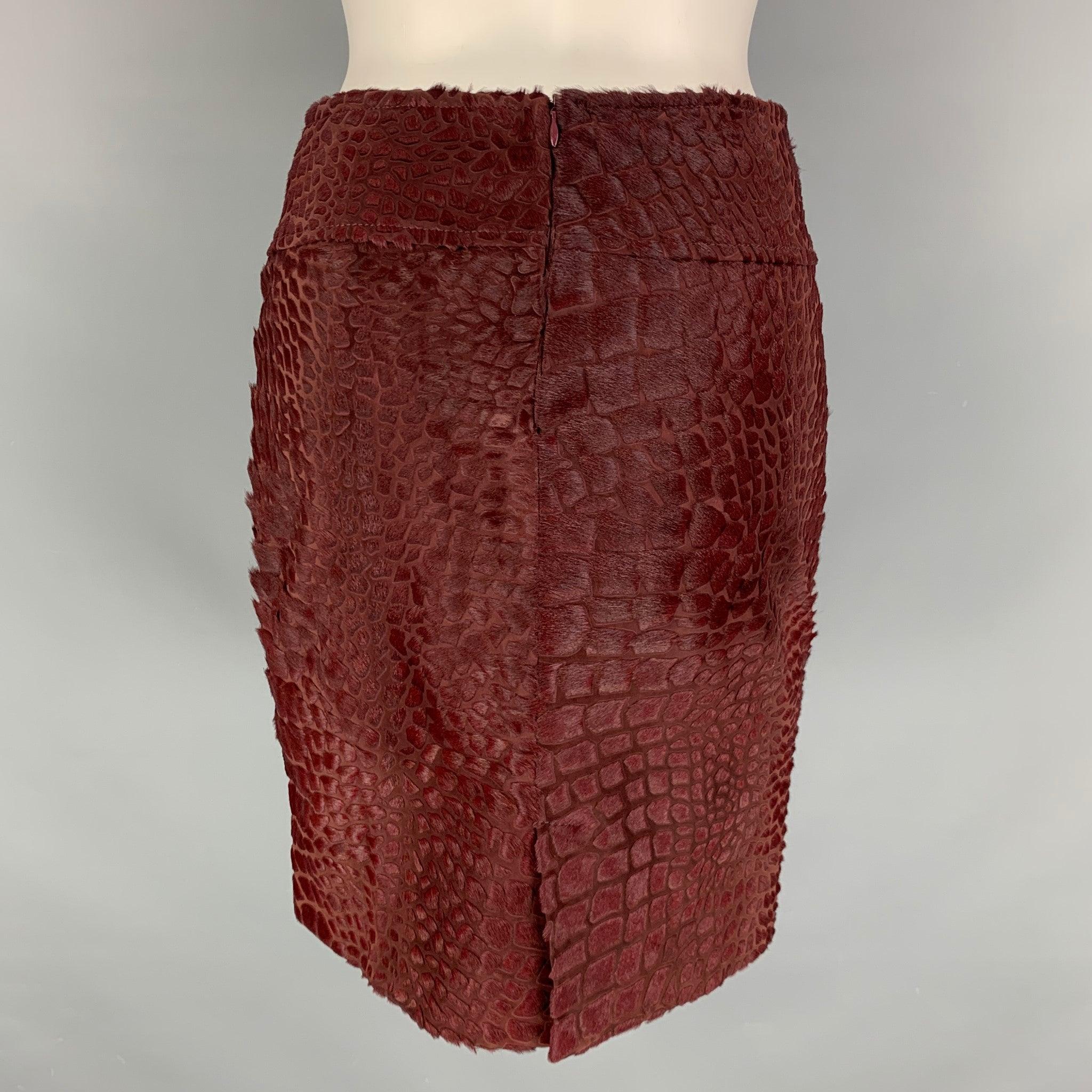SALVATORE FERRAGAMO skirt comes in a burgundy woven material features a pencil silhouette, knee length, and zip up closure at center back. Made in Italy.Excellent Pre-Owned Condition. 

Marked:   38 

Measurements: 
  Waist: 27 inches Hip: 36 inches