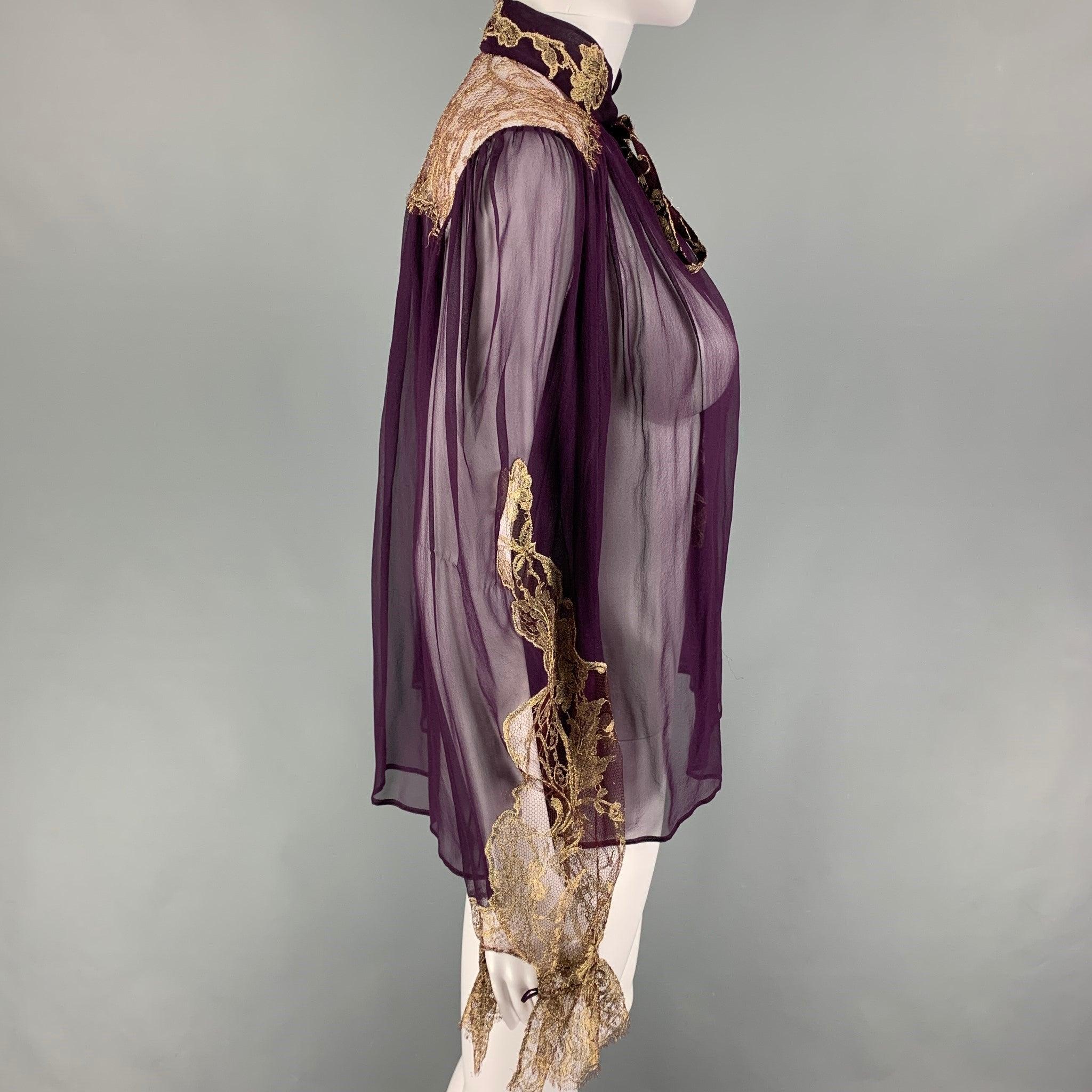SALVATORE FERRAGAMO top comes in a eggplant silk featuring a gold tone lace design, ruffled hem sleeves, and a front self-tie strap. Made in Italy.
Very Good
Pre-Owned Condition. 

Marked:  38 

Measurements: 
 
Shoulder: 15.5 inches Bust: 42 inches