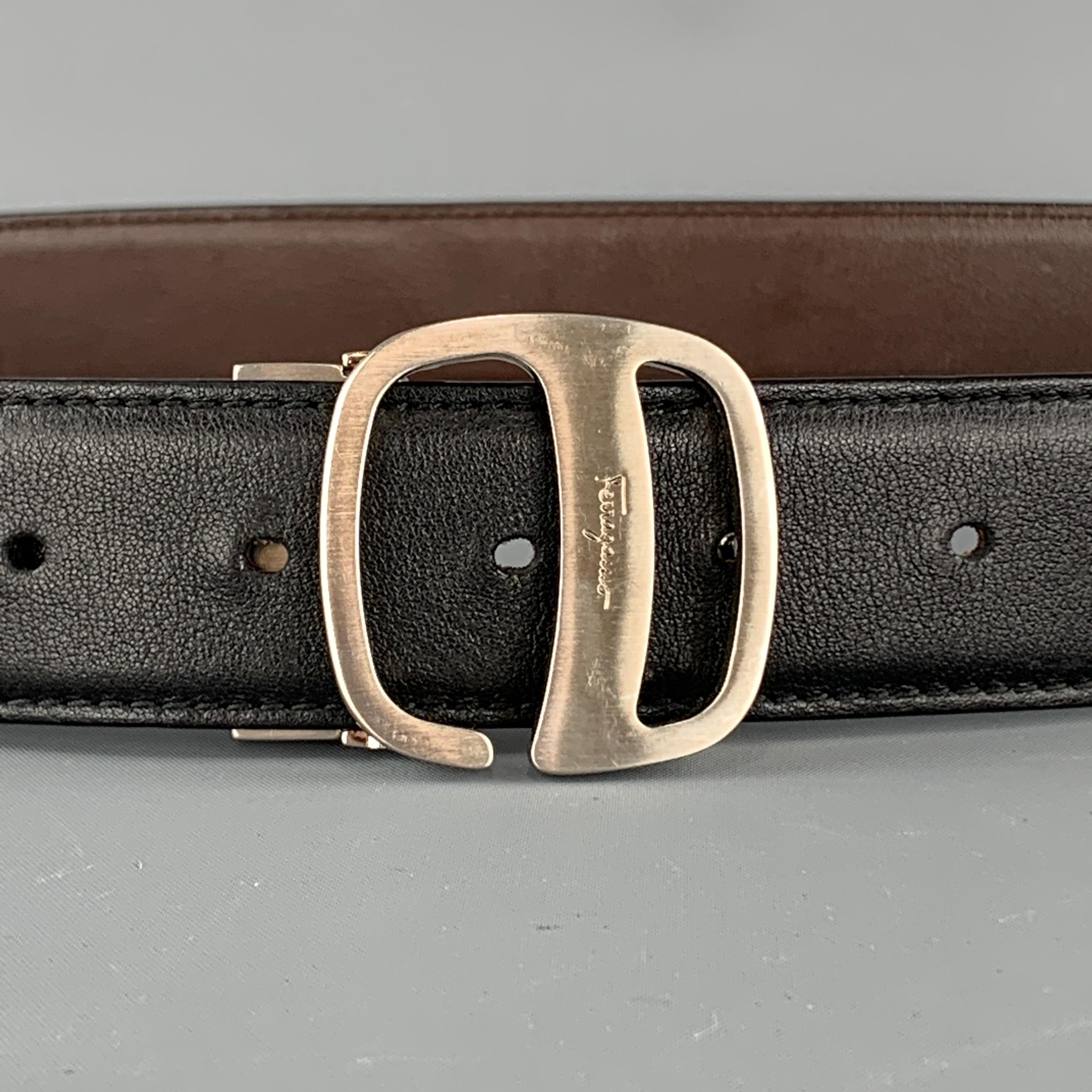 SALVATORE FERRAGAMO belt comes features a smooth black and brown reversible leather strap and a brushed silver tone buckle. Made in Italy.

Very Good Pre-Owned Condition.
Marked: (no size) 

Length: 38.5 in.
Width: 1.25 in.
Fits: 31 - 34.5 in.