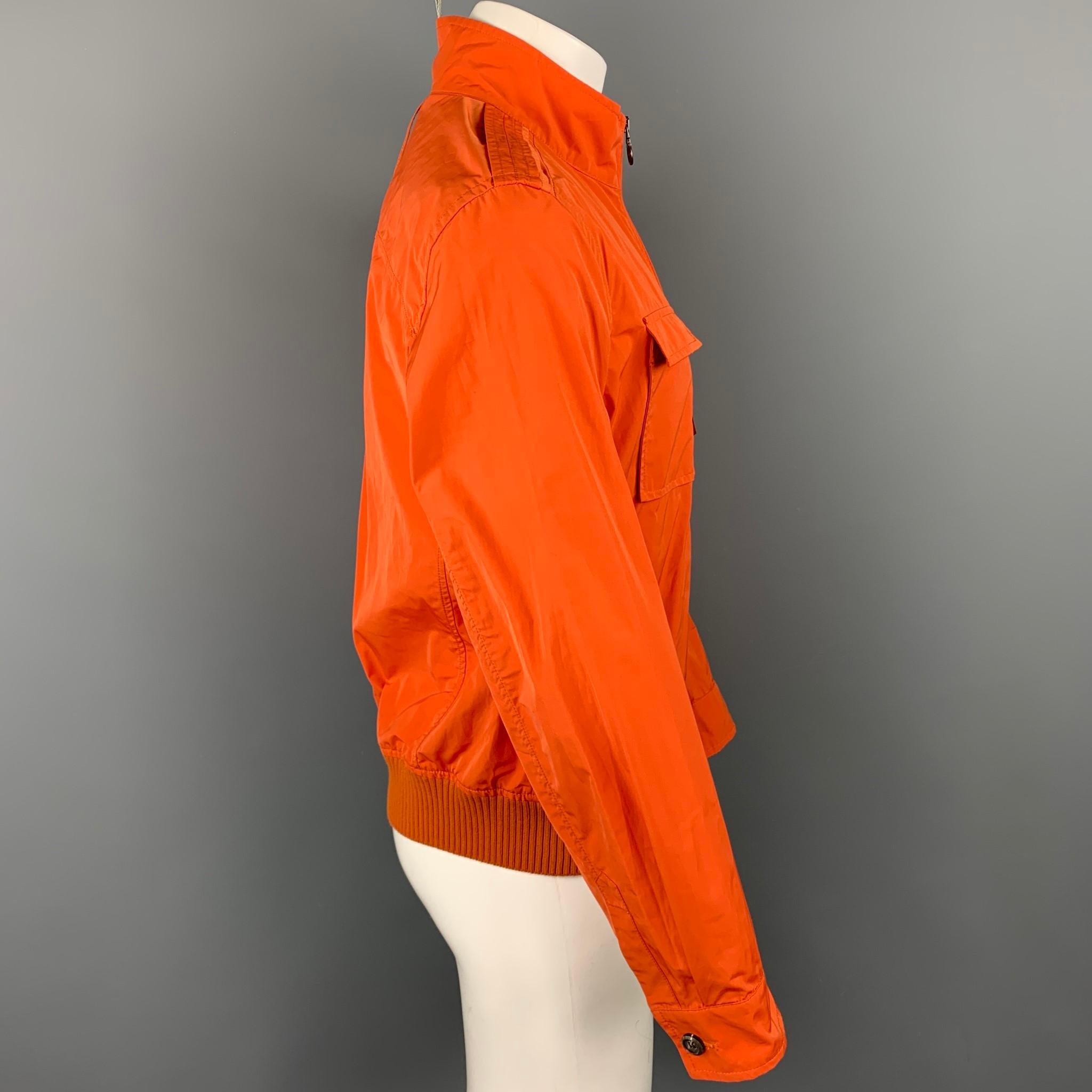 SALVATORE FERRAGAMO jacket comes in a orange polyester / cotton featuring patch pockets, ribbed hem, shoulder straps, and a full zip closure. 

New With Tags.
Marked: 50

Measurements:

Shoulder: 18.5 in.
Chest: 40 in.
Sleeve: 26 in.
Length: 25 in. 