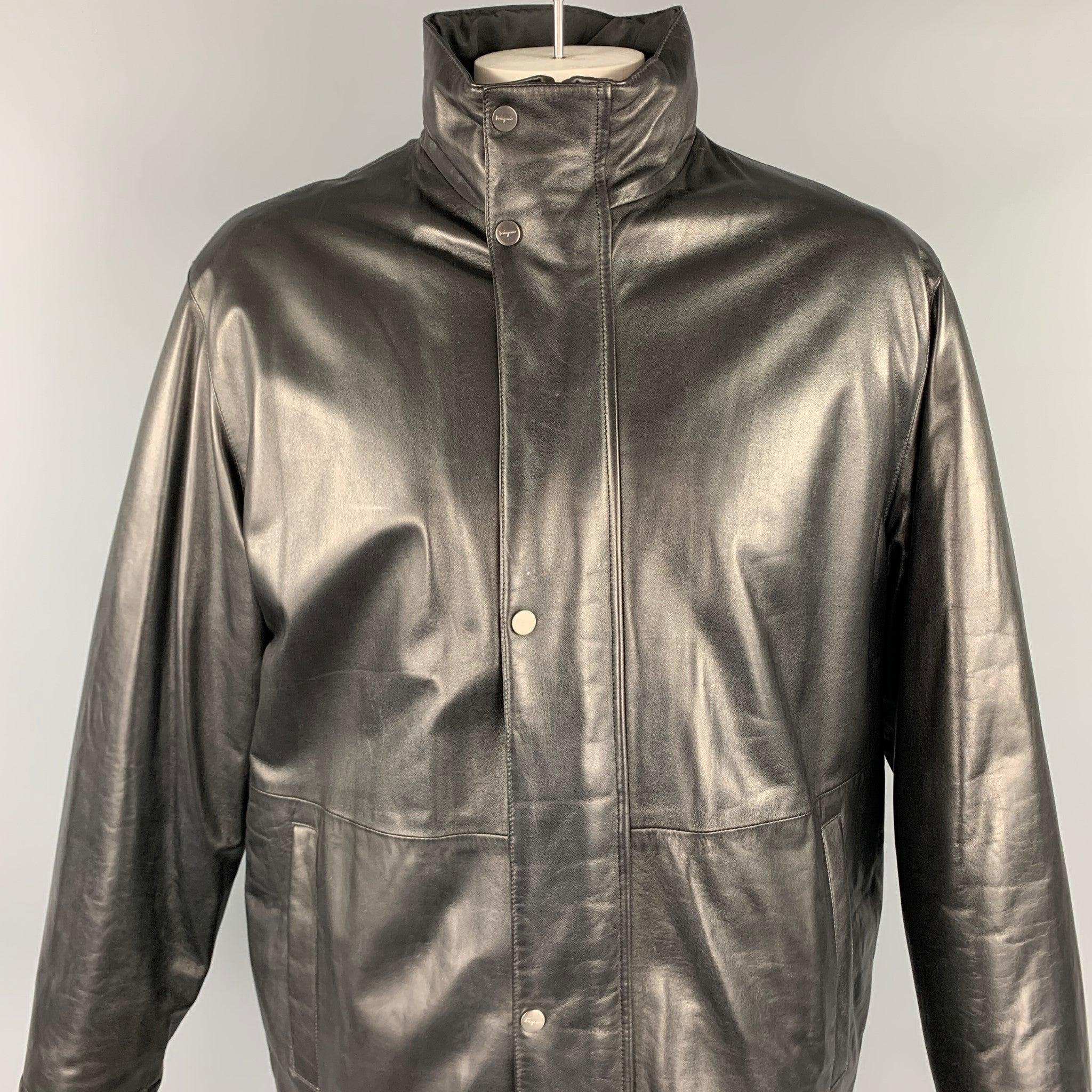 SALVATORE FERRAGAMO coat comes in a black leather featuring a reversible style, high collar, slit pockets, and a zip & snap button closure. Made in Italy.Very Good
Pre-Owned Condition. 

Marked:  52 

Measurements: 
 
Shoulder: 22 inches Chest: 50