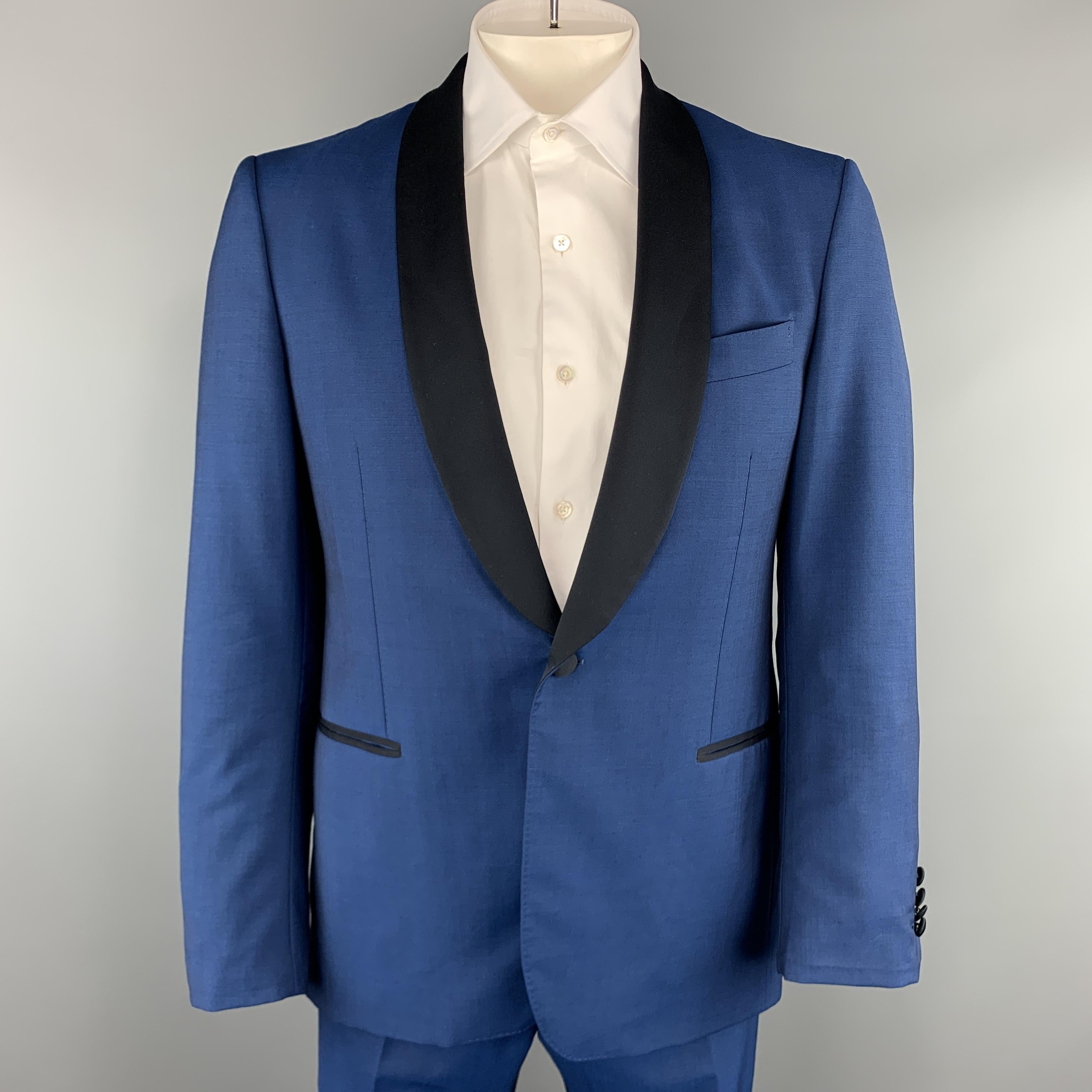 SALVATORE FERRAGAMO tuxedo suit comes in blue wool blend sharkskin and includes a single breasted, one button sport coat with black satin shawl collar lapel and matching flat front  front tuxedo stripe trousers. Made in Italy.

Excellent Pre-Owned