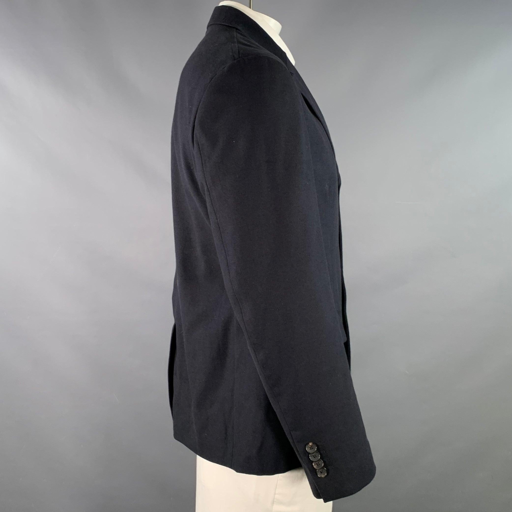 SALVATORE FERRAGAMO sport coat
in a navy virgin wool cotton blend twill featuring a notch lapel, single vented back, and three button closure. Made in Italy.Very Good Pre-Owned Condition. Minor signs of wear. 

Marked:   IT 52 

Measurements: 
