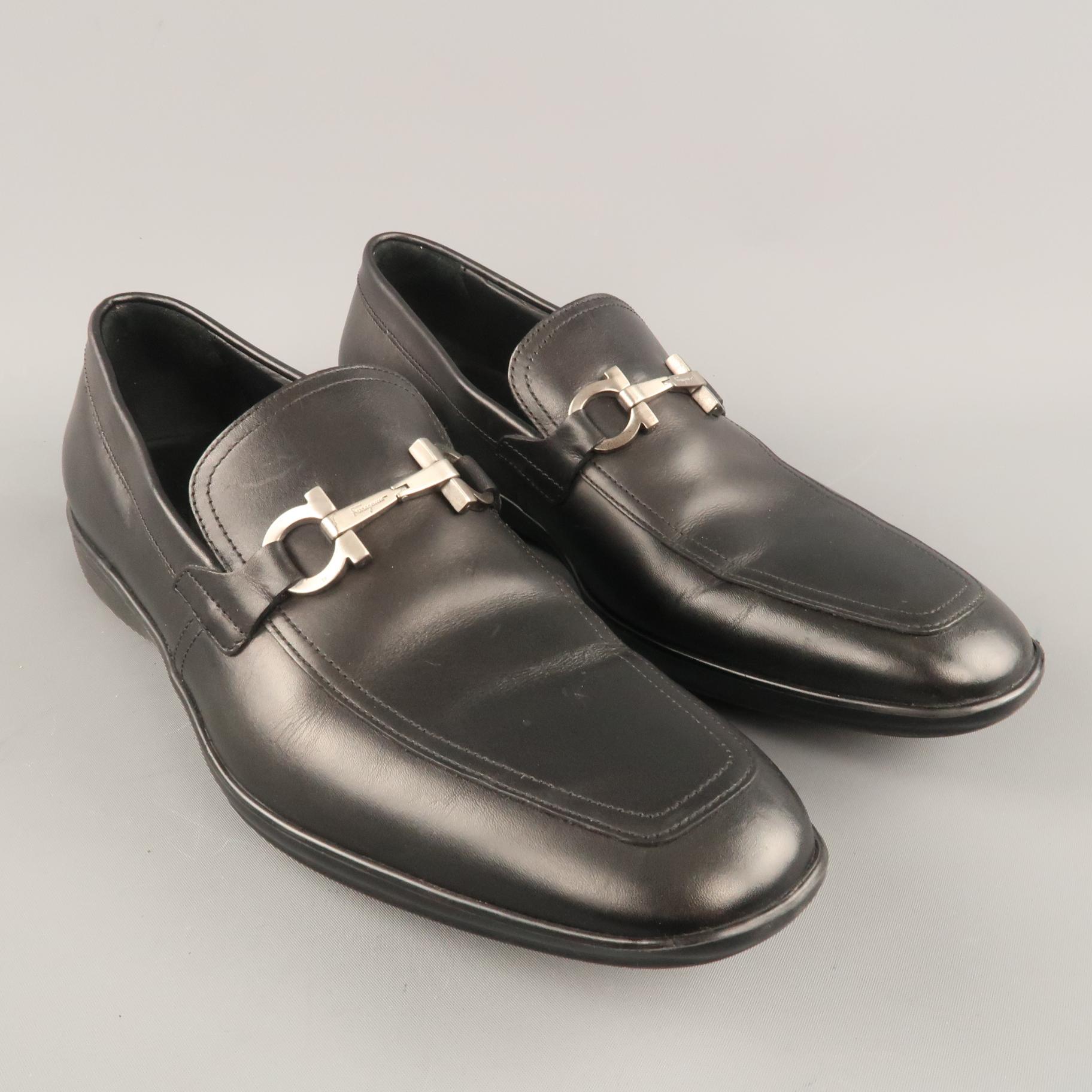 SALVATORE FERRAGAMO loafers come in black leather with an apron toe, rubber sole, and matte silver tone metal Gancini hardware. Made in Italy.
 
Excellent Pre-Owned Condition.
Marked: UK 7 1/2
 
Outsole: 11.5 x 3.75 in.