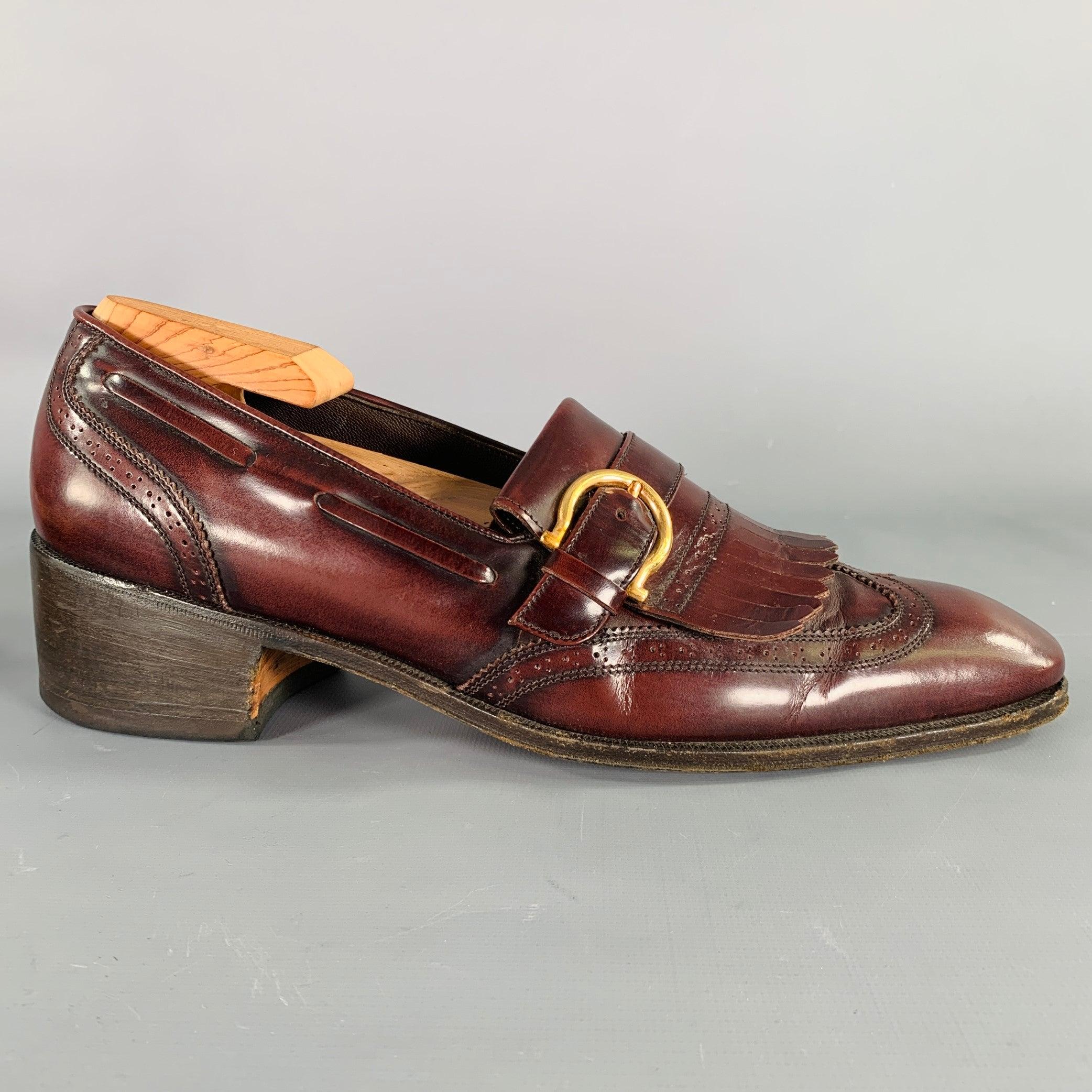 SALVATORE FERRAGAMO loafers
in a burgundy leather featuring a perforated style with wingtip design, tassel details, and gold tone Ferragamo buckle. Shoe trees not included. Made in Italy.Excellent Pre-Owned Condition. 

Marked:   UG52482 C 15 8