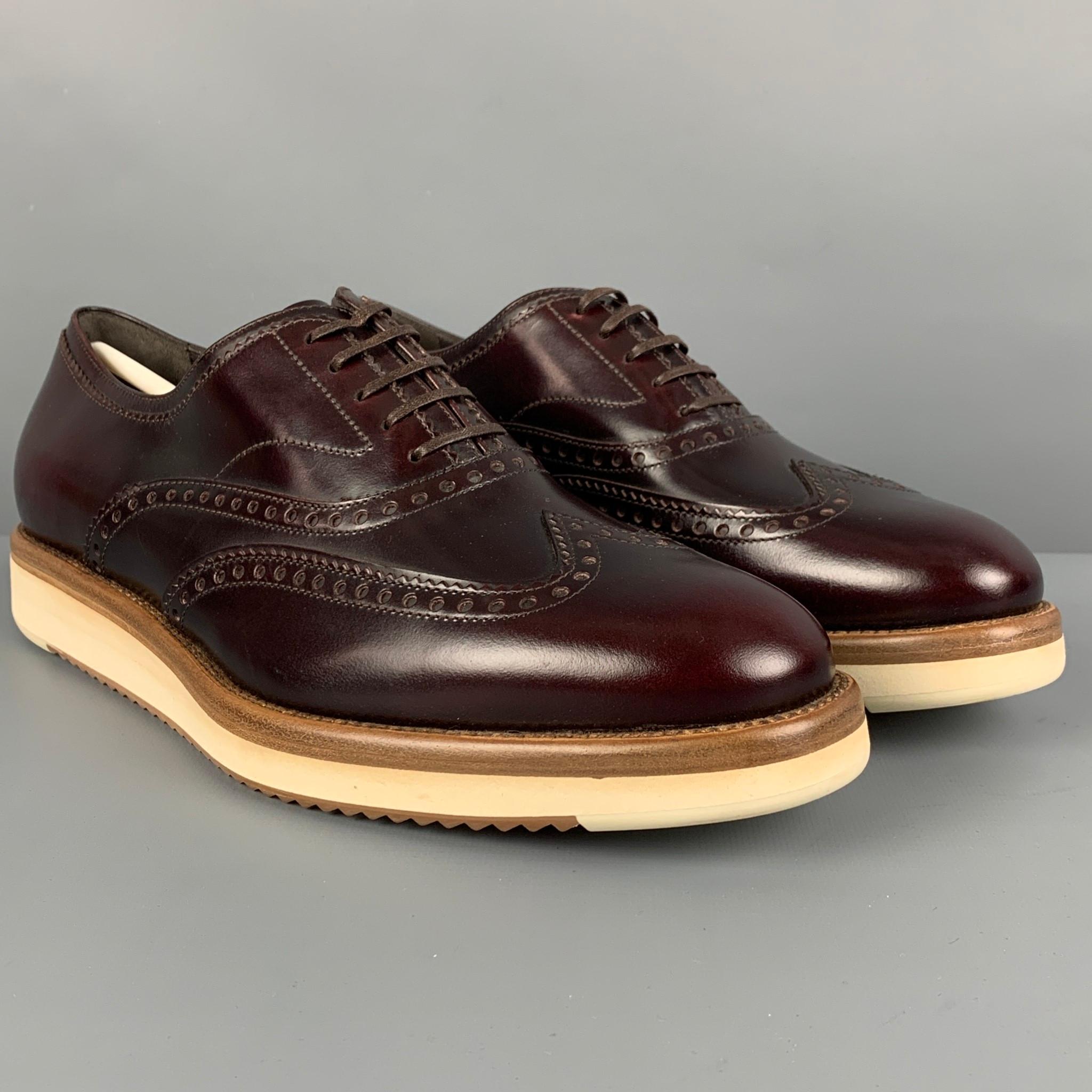 SALVATORE FERRAGAMO shoes comes in a burgundy perforated leather featuring a wing tip style and a lace up closure. Made in Italy. 

New Without Tags.
Marked: LC 34967 7 3E

Outsole: 11.5 in. x 4 in. 