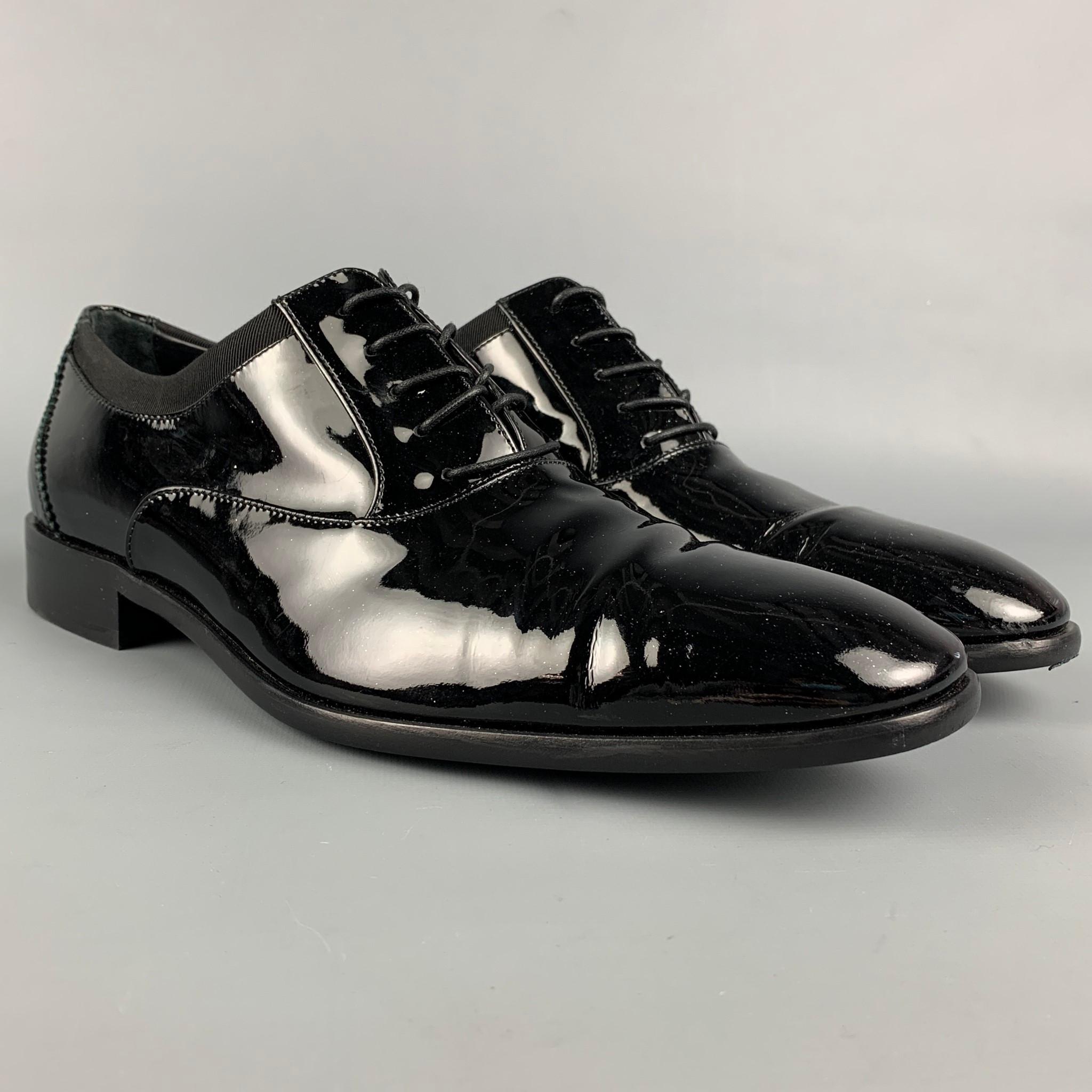 SALVATORE FERRAGAMO shoes comes in a black patent leather featuring a square toe, ribbon trim, and a lace up closure. Made in Italy. 

Very Good Pre-Owned Condition.
Marked: VF 77977 8.5 2 E

Outsole: 12 in. x 4 in. 