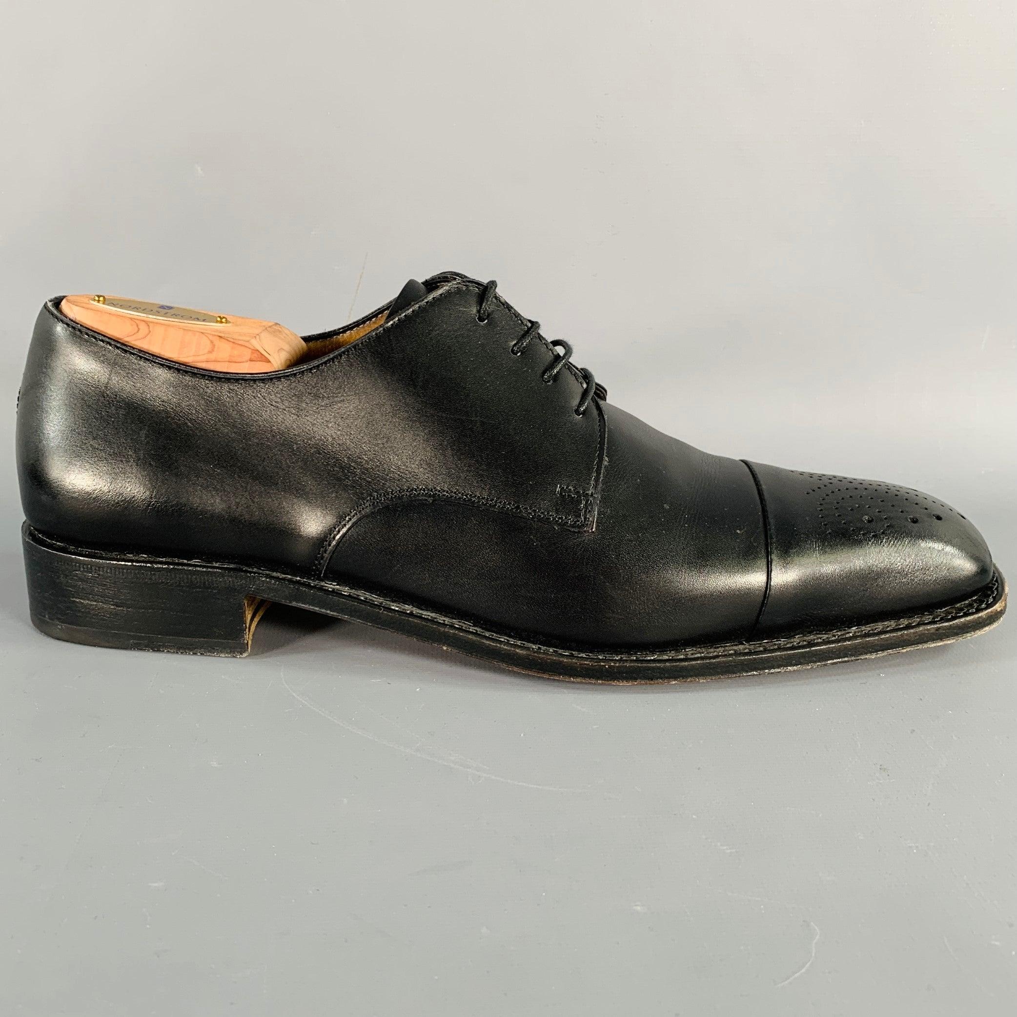 SALVATORE FERRAGAMO shoes
in a black leather featuring a perforated cap toe design, derby style, and lace-up closure. Comes with dust bag. Made in Italy.Excellent Pre-Owned Condition. 

Marked:   TD8078 3701 21U 8.5 1DOutsole: 11.75 inches  x 3.75