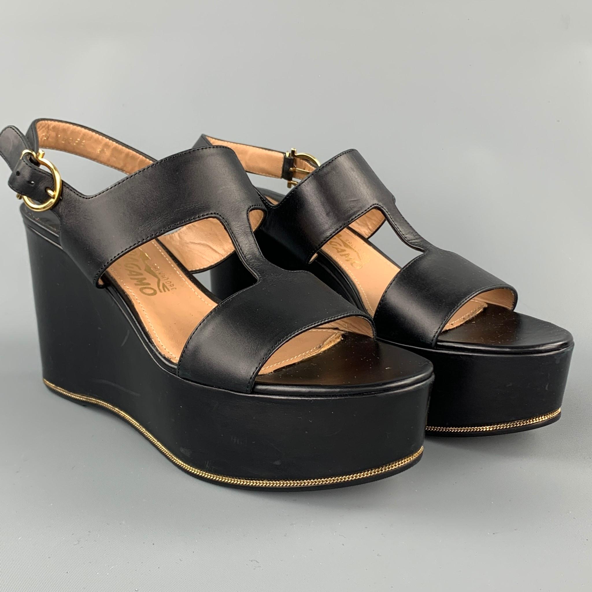 SALVATORE FERRAGAMO sandals comes in a black leather with a gold tone chain detail featuring a platform style and a strap closure. Made in Italy.

Very Good Pre-Owned Condition.
Marked: 8.5 B

Measurements:

Platform: 1.5 in. 
  
