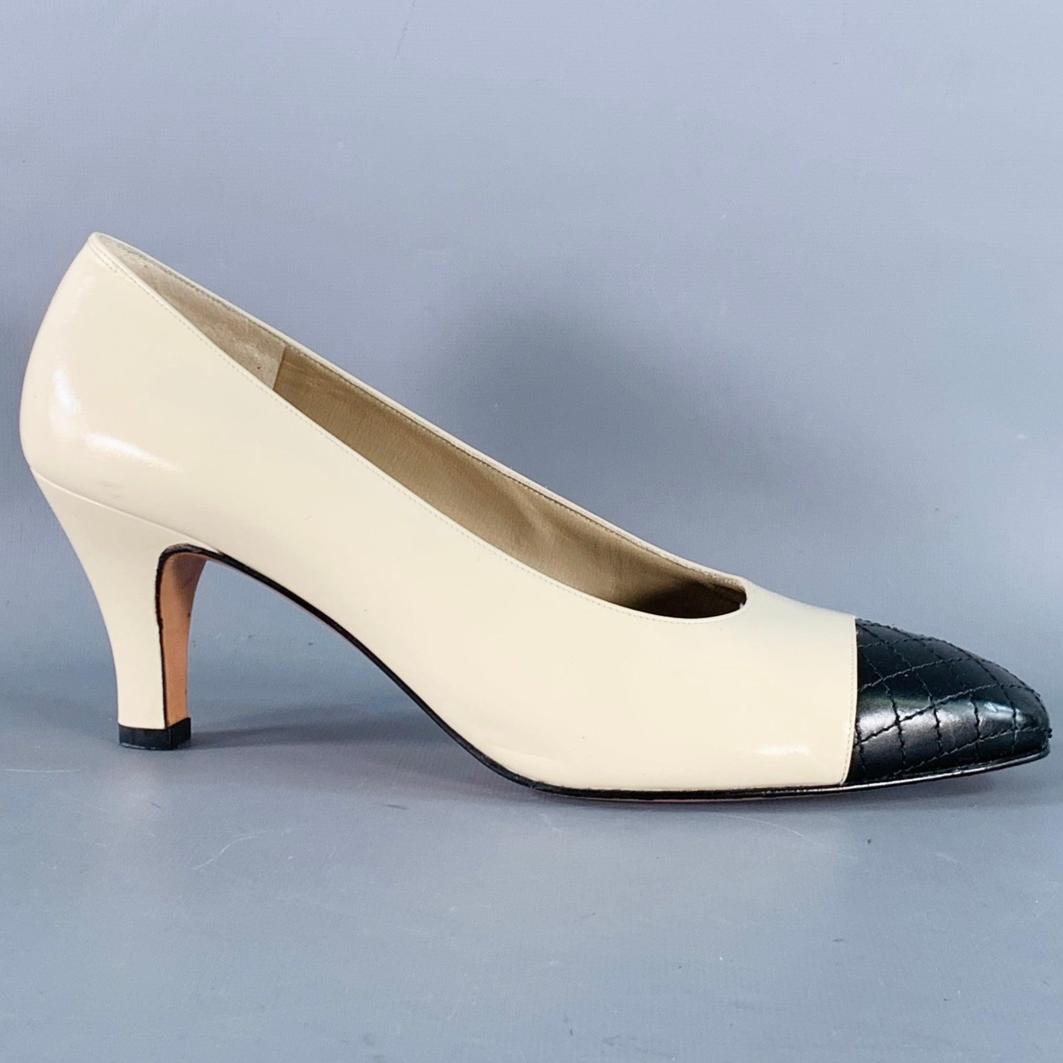 SALVATORE FERRAGAMO pumps in a beige leather featuring black quilted cap toe detail, and slip on closure. Made in Italy.Excellent Pre-Owned Condition. 

Marked:   DQ 42277 9 B 269 

Measurements: 
  Heel: 3 inches 
  
  
 
Sui Generis Reference: