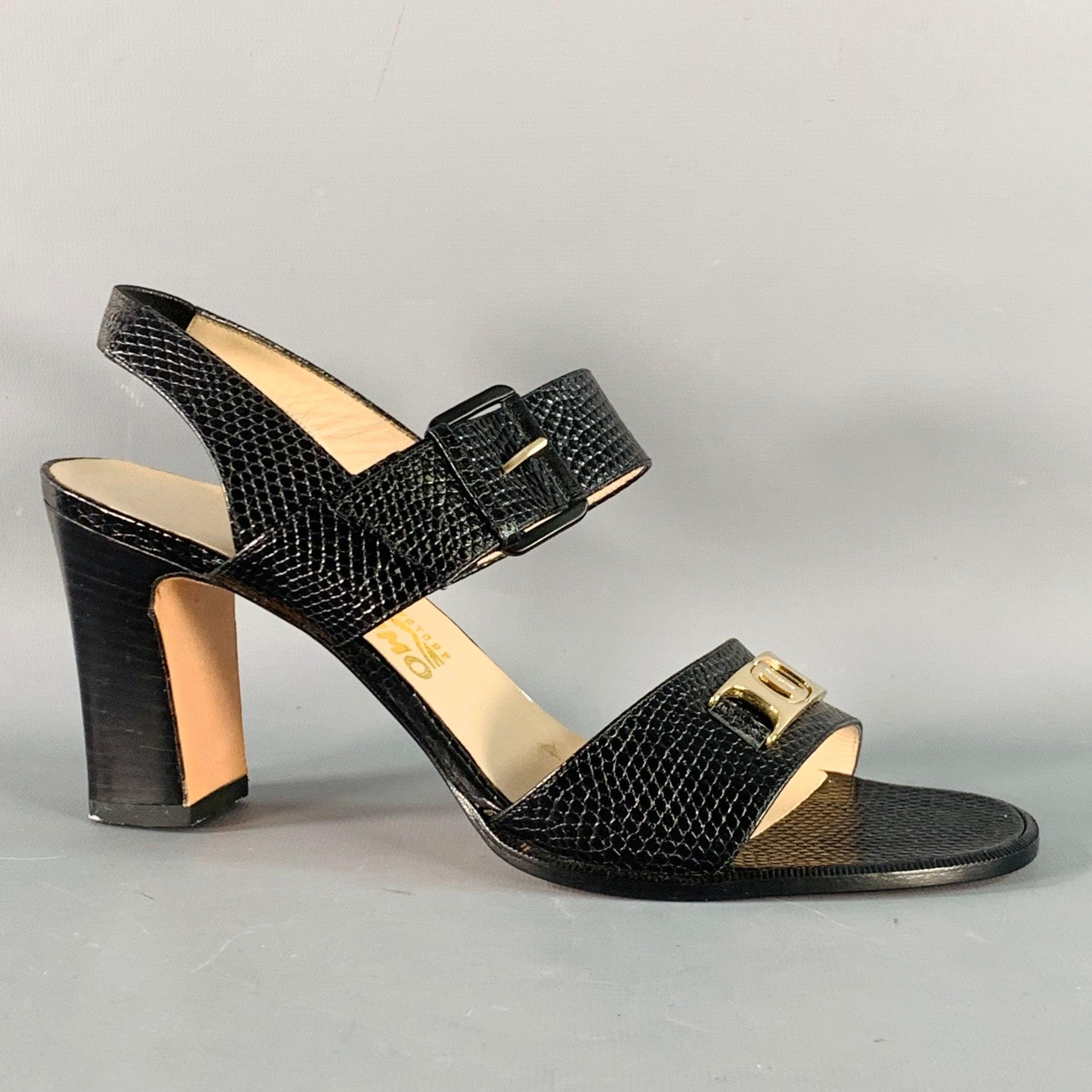 SALVATORE FERRAGAMO sandals
in a black snake embossed leather featuring a strappy style with elastic slingback strap, gold tone metal logo details, chunky stacked heel, and buckle closure. Made in Itay.Excellent Pre-Owned Condition. 

Marked:   DK