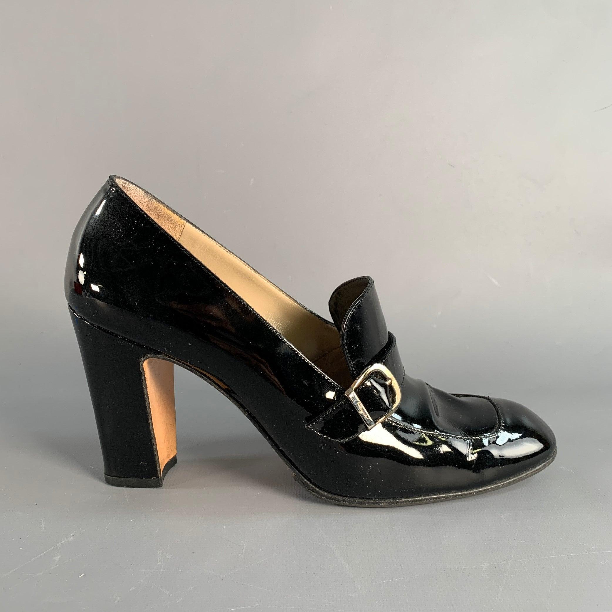 SALVATORE FERRAGAMO pumps in a black patent leather featuring a chunky kitten heel, with signature FERRAGAMO silver tone buckle. Made in Italy.Very Good Pre-Owned Condition. 

Marked:   DD11855A 86 9B 

Measurements: 
  Heel: 3.75 inches 
  
  
