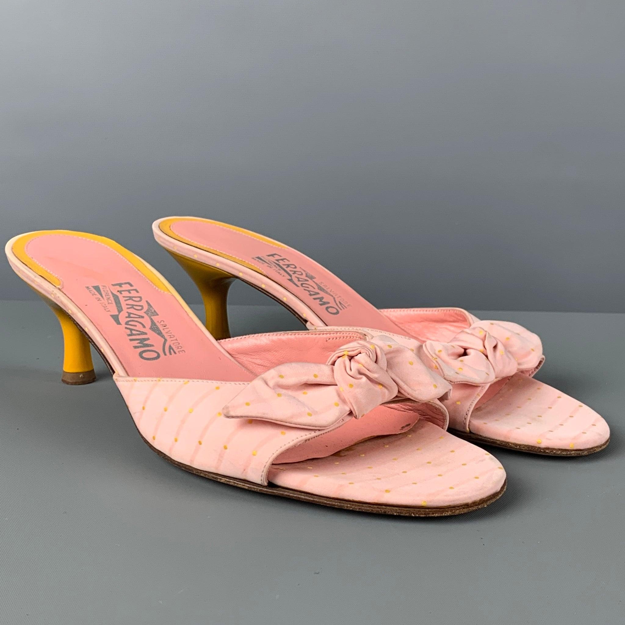 SALVATORE FERRAGAMO sandals comes in a pink print material featuring a front bow design, open toe, and a yellow kitten heel. Made in Italy.Good
Pre-Owned Condition. Moderate wear. As-is.  

Marked:   9 B  

Measurements: 
Heel: 2.25 inches 
  
  
