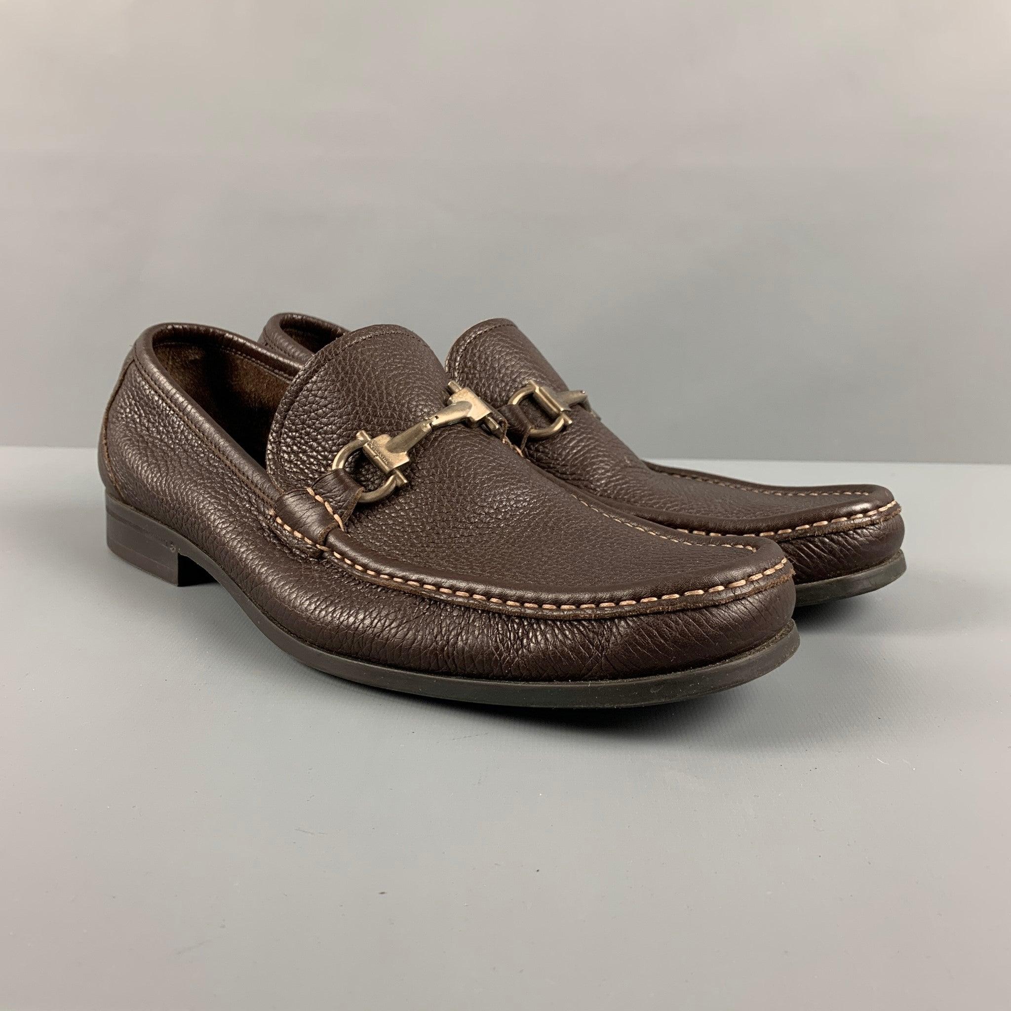 SALVATORE FERRAGAMO loafers comes in a brown pebble grain leather featuring a horse bit detail, and a slip on detail. Includes dust bag. Made in Italy.Very Good Pre-Owned Condition. Minor signs of wear. 

Marked:   TN 13547 9 1/2 1dOutsole: 10.5