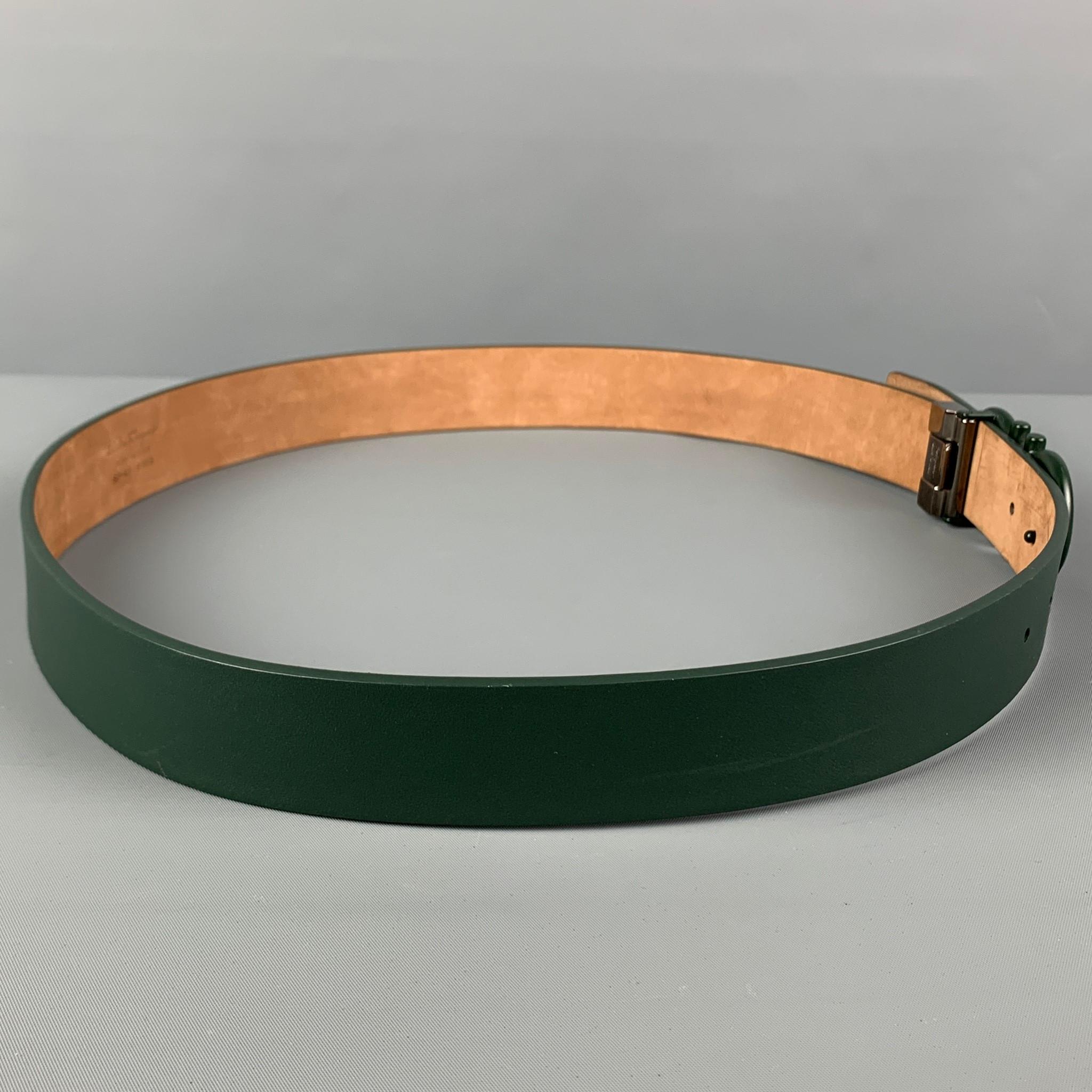 SALVATORE FERRAGAMO belt comes in a dark green leather featuring a dark green logo buckle closure. Made in Italy. 

Very Good Pre-Owned Condition.
Marked: SP-67 9955
Original Retail Price: $575.00

Length: 41 in.
Width: 1.25 in.
Fits: 34.5 in. -
