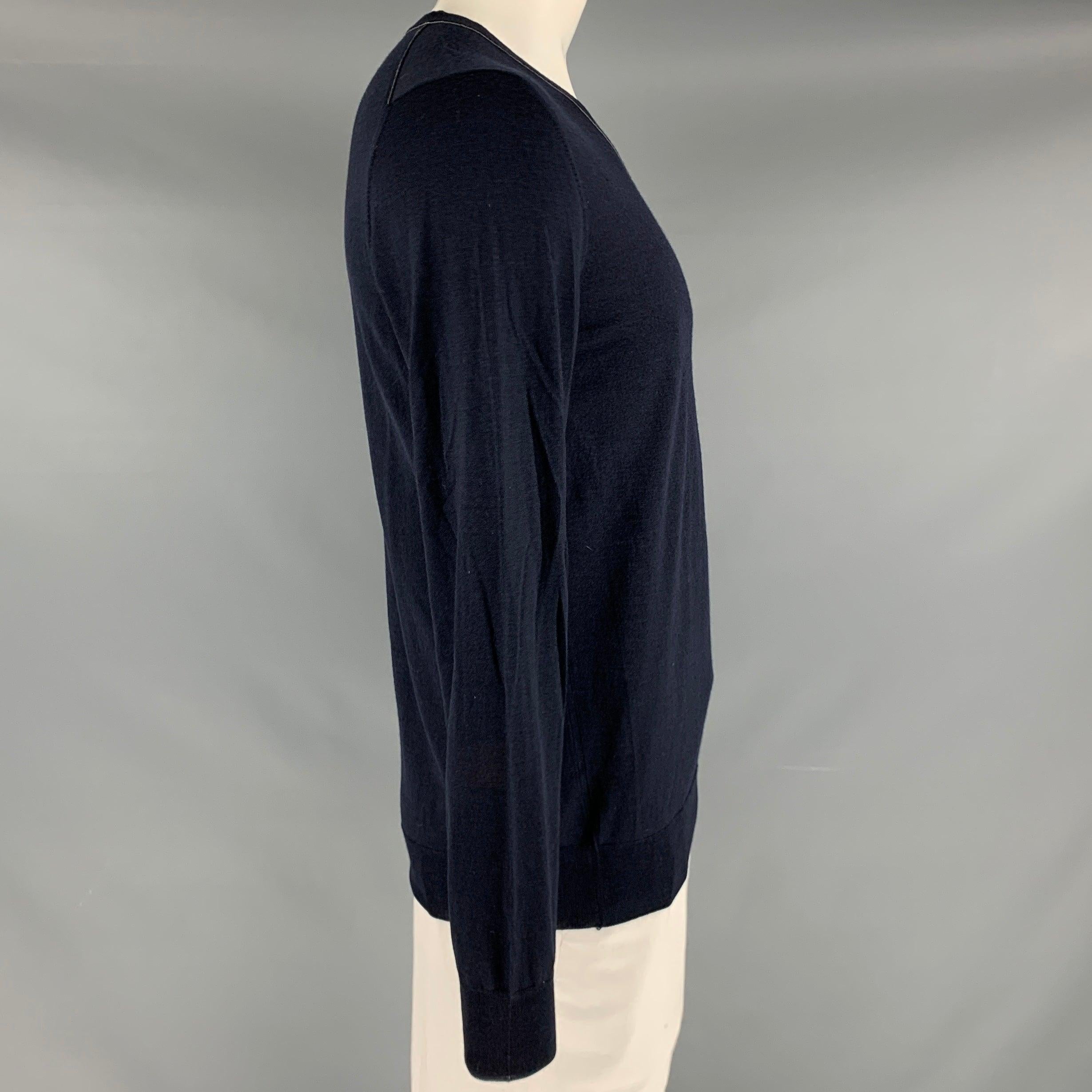 SALVATORE FERRAGAMO pullover
in a navy wool silk blend knit featuring grey trim, blouson sleeves, and V-neck. Made in Italy.Very Good Pre-Owned Condition. Minor signs of wear. 

Marked:   XL 

Measurements: 
 
Shoulder: 17.5 inches Chest: 42 inches