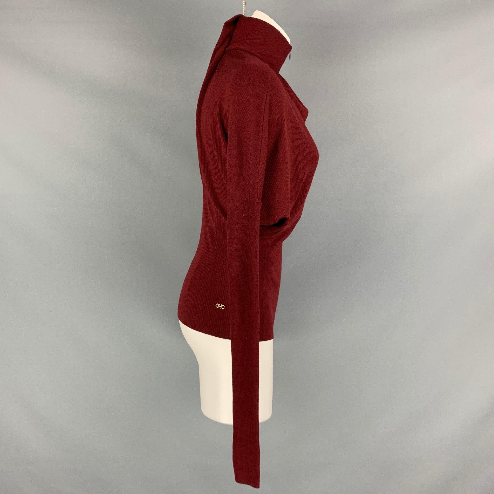 SALVATORE FERRAGAMO pullover comes in burgundy virgin wool ribbed knit material features a Dolman sleeves and high neck. Made in Italy.Excellent Pre-Owned Condition. 

Marked:   XS 

Measurements: 
 
Shoulder: 16 inches Chest: 36 inches Sleeve: 28