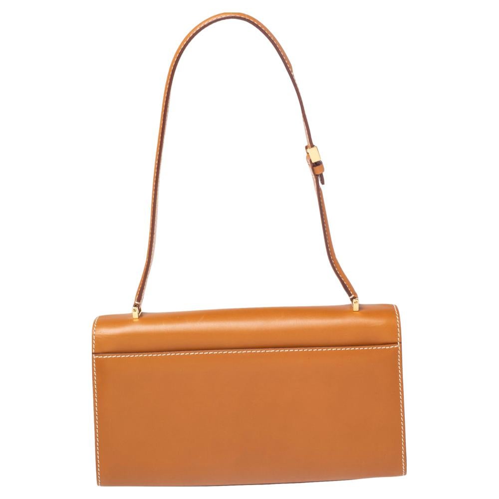 This tan flap bag from the house of Salvatore Ferragamo is lovely. It is crafted from leather and designed with a shoulder handle and the Gancini logo on the flap. This piece will do justice to your style in an easy way.

Includes: Original Dustbag,