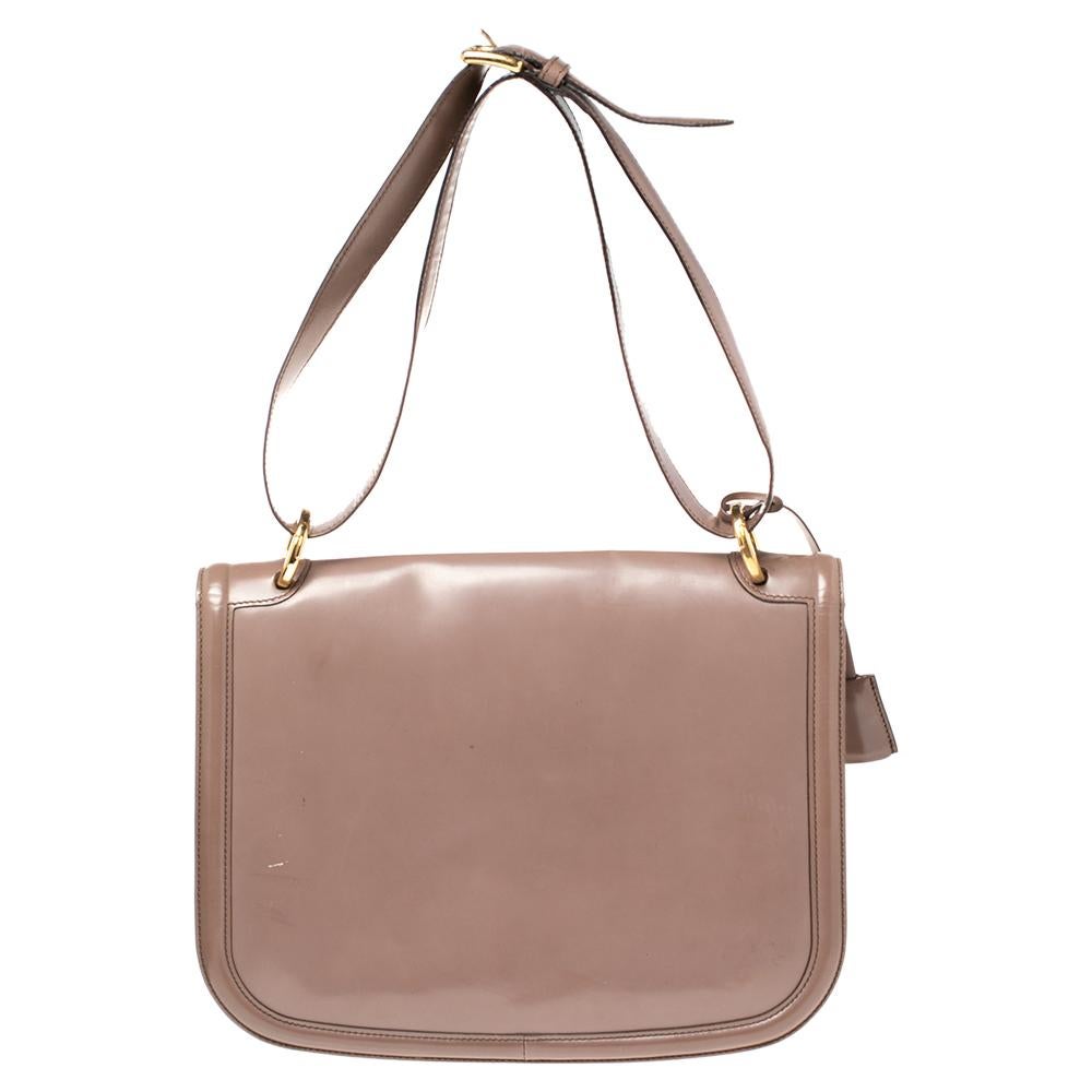 This Jody shoulder bag by Salvatore Ferragamo in leather is accented with gold-tone hardware. Its curved flap features a gold-tone logo lock closure. It is complete with an adjustable shoulder strap and a fully lined interior.

Includes: Detachable