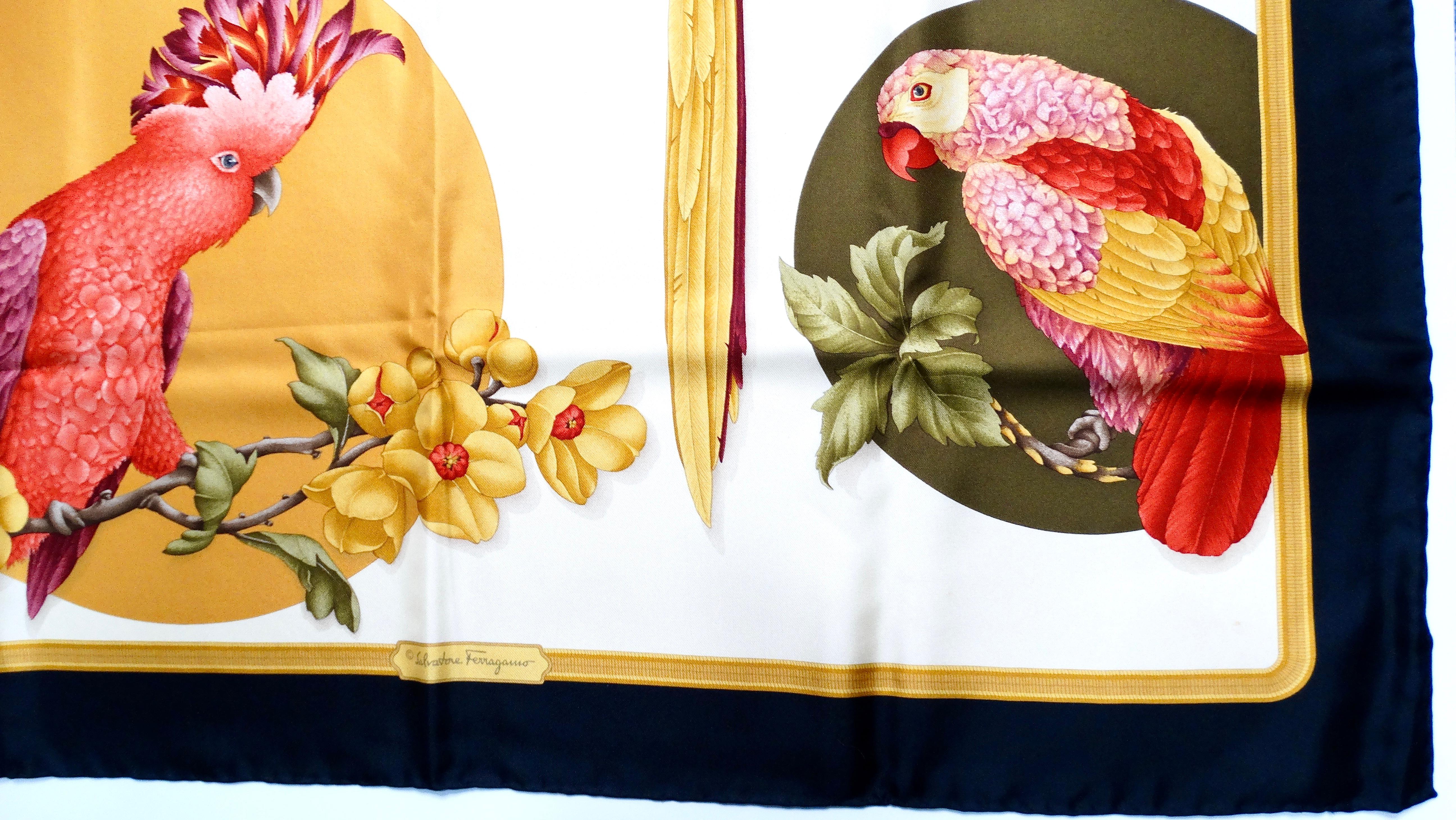 The Salvatore Ferragamo Tropical Bird Print Silk Scarf is a stunning accessory that captures the vibrant beauty of exotic avian life. Crafted from luxurious silk, this scarf features a striking design of parrots and parakeets set against a sleek