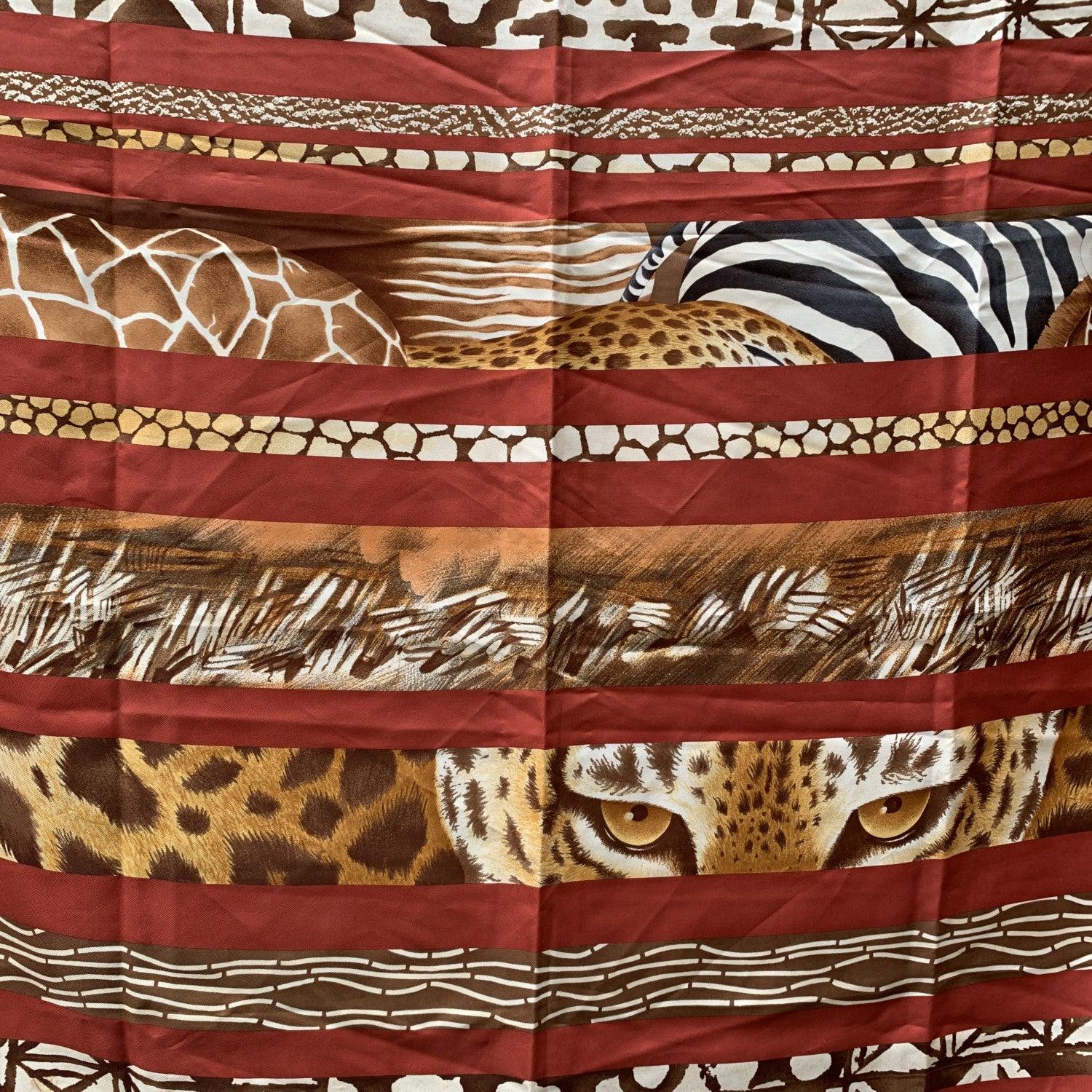 Vintage Salvatore Ferragamo brown silk scarf. Animalier print with brown striped pattern. Hand rolled edges. Made in Italy. Composition: 100% silk. Approx. measurements: 34.5 x 34.5 inches - 87.5 x 87.5 cm. 'Salvatore Ferragamo' signature printed on