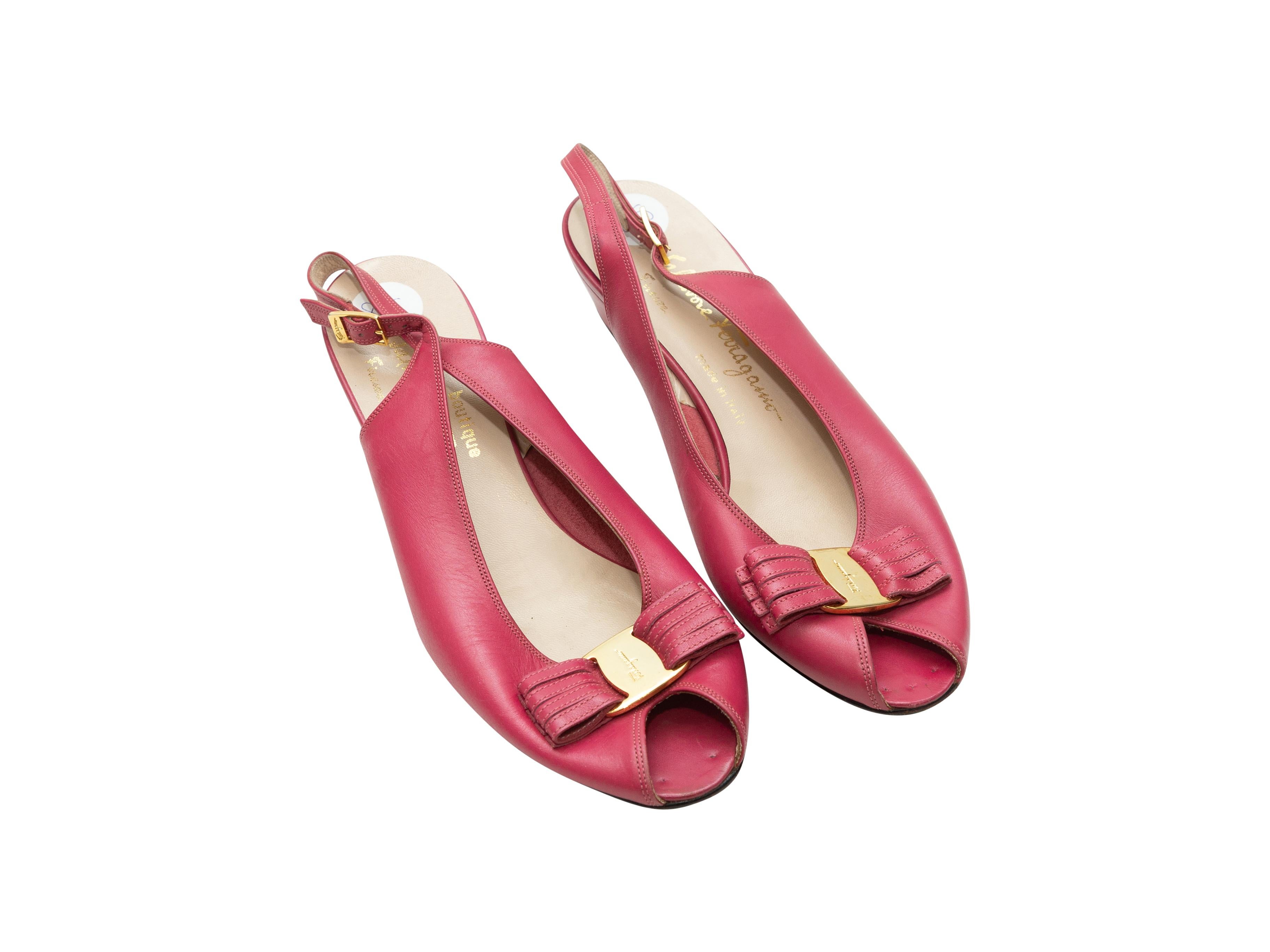 Product details: Vintage pink leather peep-toe slingback pumps by Salvatore Ferragamo. Gold-tone hardware. Bow accents at tops. Buckle closures at straps. 1.5