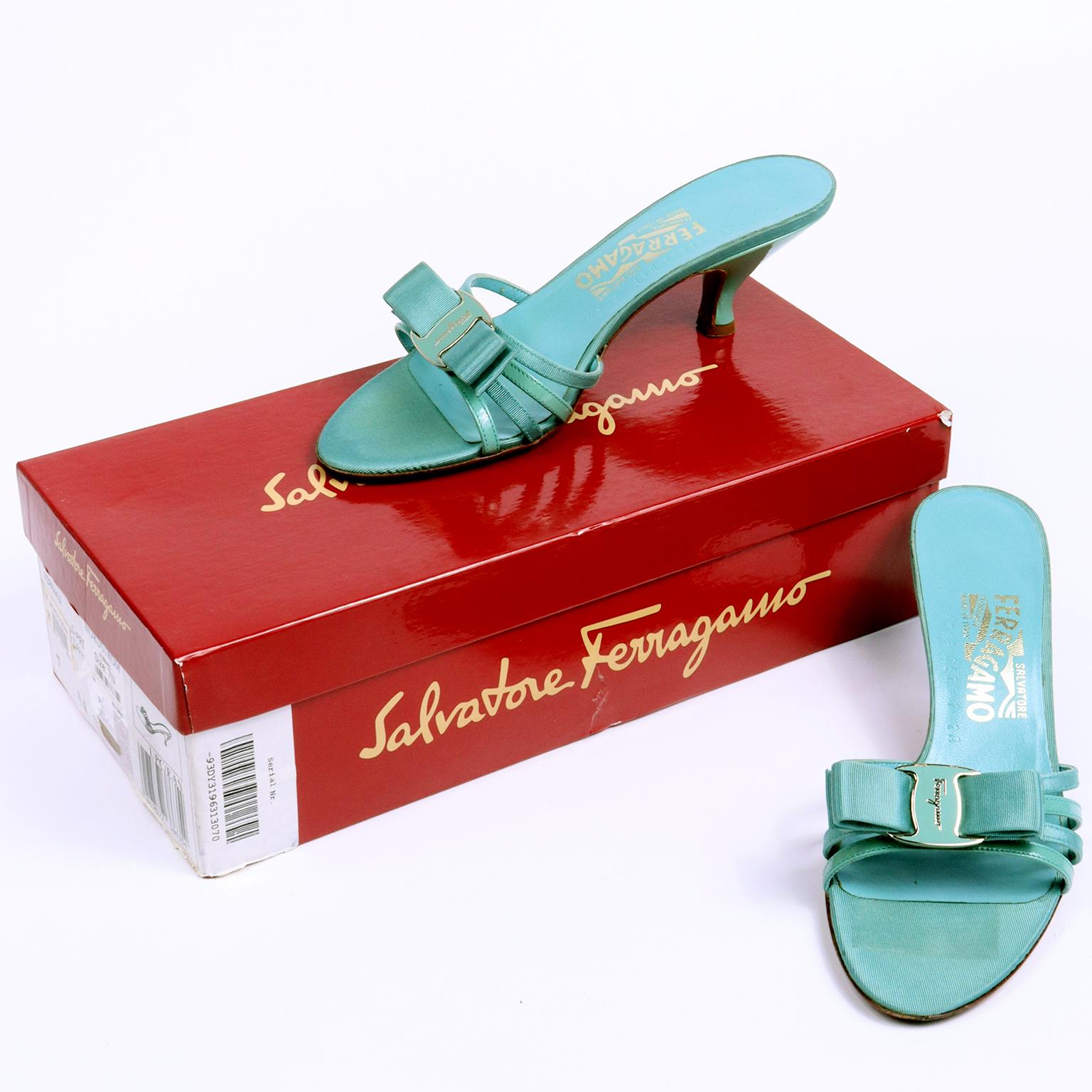 These fun vintage Salvatore Ferragamo sandals are in a pretty turquoise blue leather and grosgrain and were only worn once or twice! The shoes have a nice, comfortable heel and the signature Ferragamo bow with a blue and silver monogram enamel