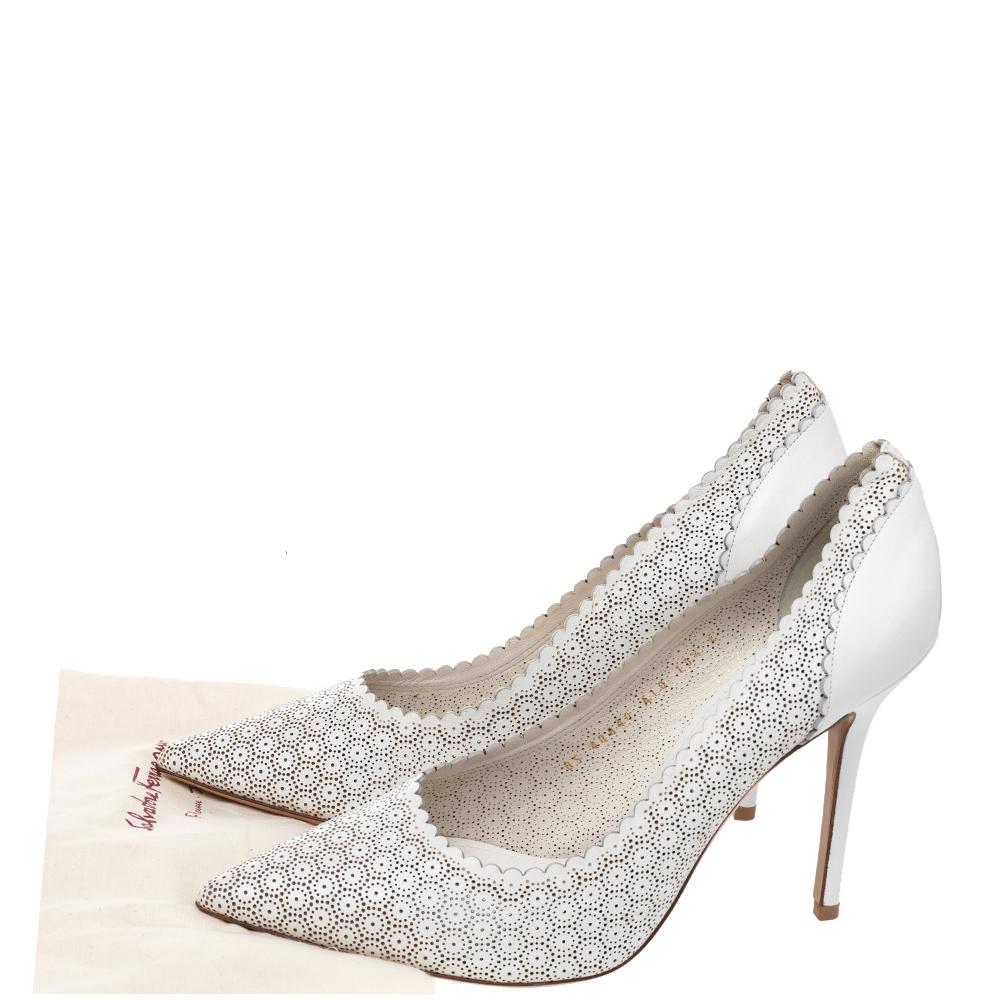 These Salvatore Ferragamo white laser-cut leather Susi pointed-toe pumps are the perfect addition to your summer wardrobe. They are chic, unique, and the ideal finishing touch to any ensemble.

