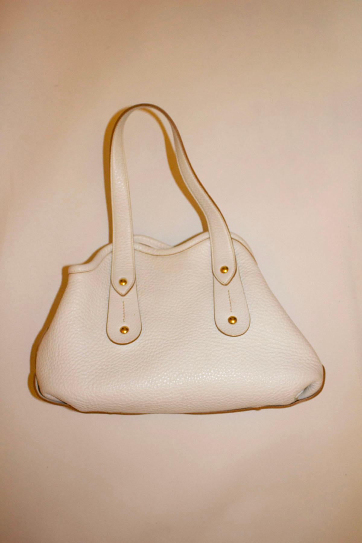 A wonderful bag for Spring / Summer by Salvatore Ferragamo. In a wonderful soft white leather, the bag has no frame but has an internal strap to keep it in shape. It has an internal pocket, two handles and is unlined  Model AU -217286 .