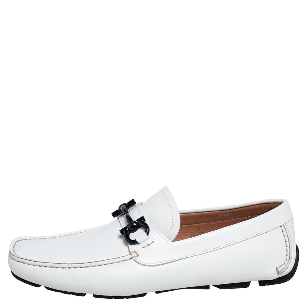 Crafted from leather and styled in a neat silhouette, this pair of white loafers by Tod's is a true blend of luxury and comfort. Made in Italy, they feature round toes, black-tone horsebit buckles with an engraved brand name, leather-lined insoles,