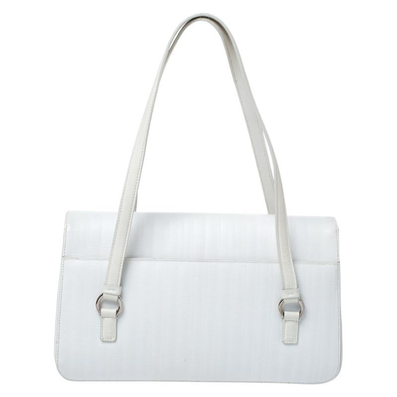 Made from white leather, this bag is both reliable and stylish. It comes in a flap style with features such as two handles, silver-tone hardware and a fabric interior. This accessory from Salvatore Ferragamo will do justice to both style and