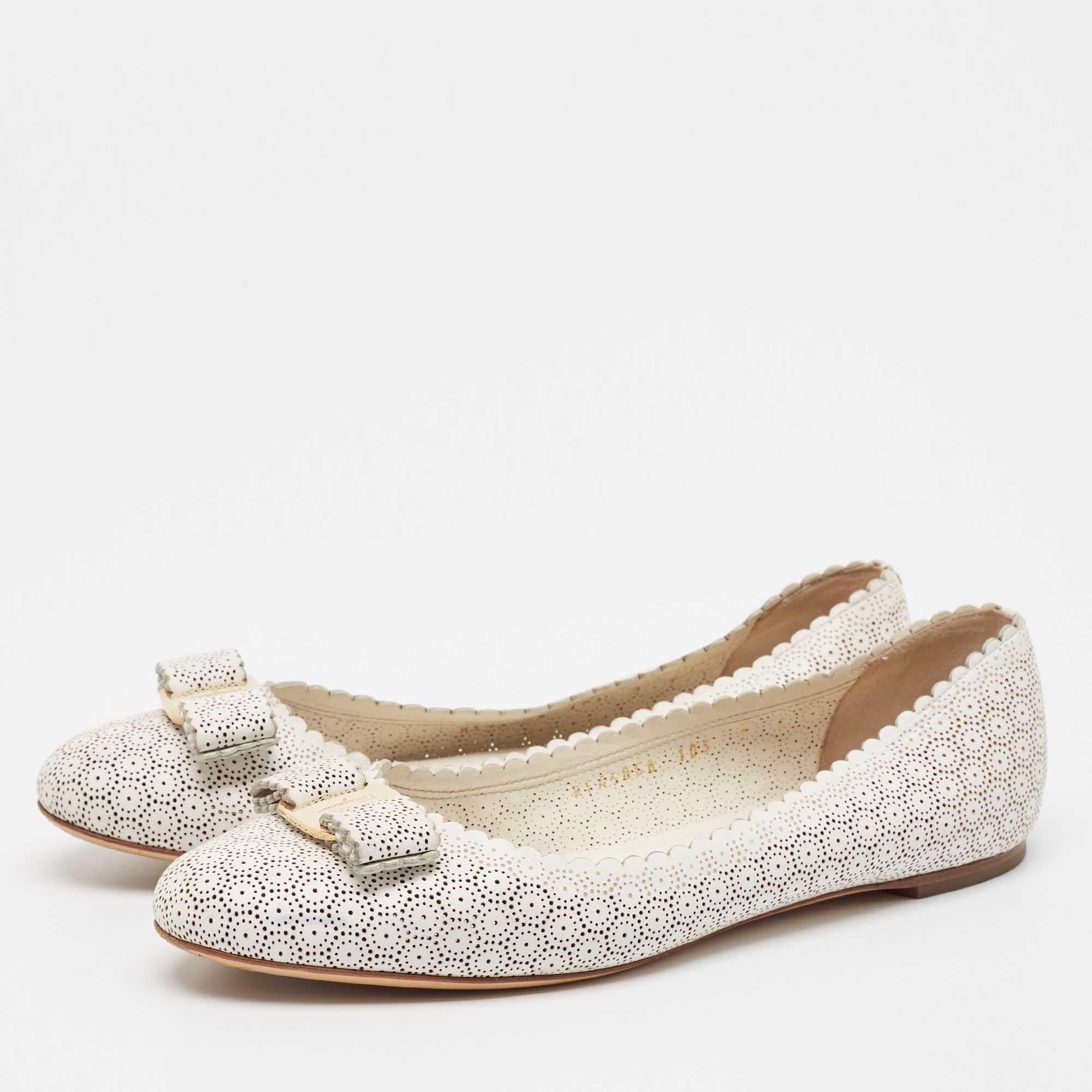These ballet flats by Salvatore Ferragamo are comfortable and chic to be matched with everything from a shirt dress to skinny jeans. Crafted from white perforated leather they feature round toes with the signature bow.