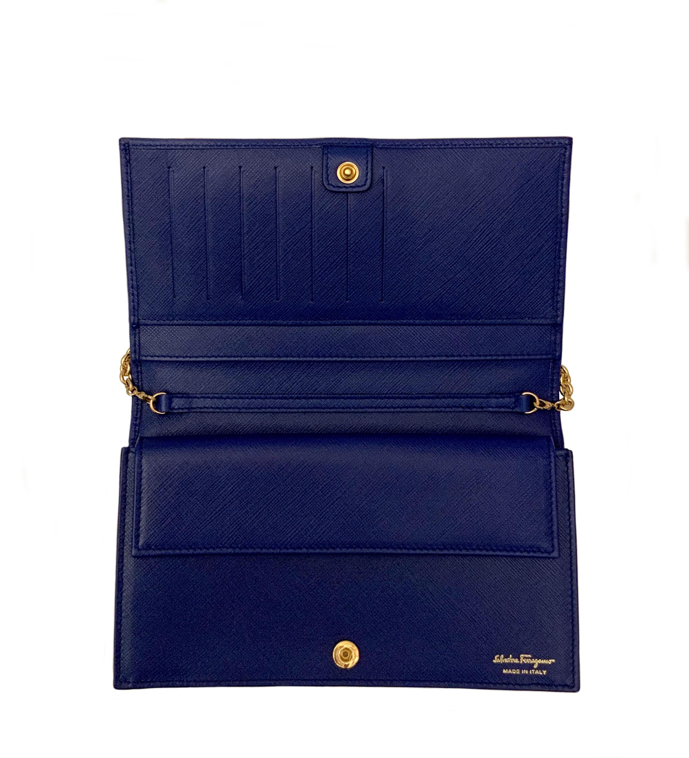 This pre-owned but new Miss Vara WOC cross-body bag from the house of Ferragamo is crafted from a beautiful blue Saffiano leather. 
It features a Vara bow in a matching blue gros grain as a clasp closure. (Plastic on gold part)
The inside offers 7x