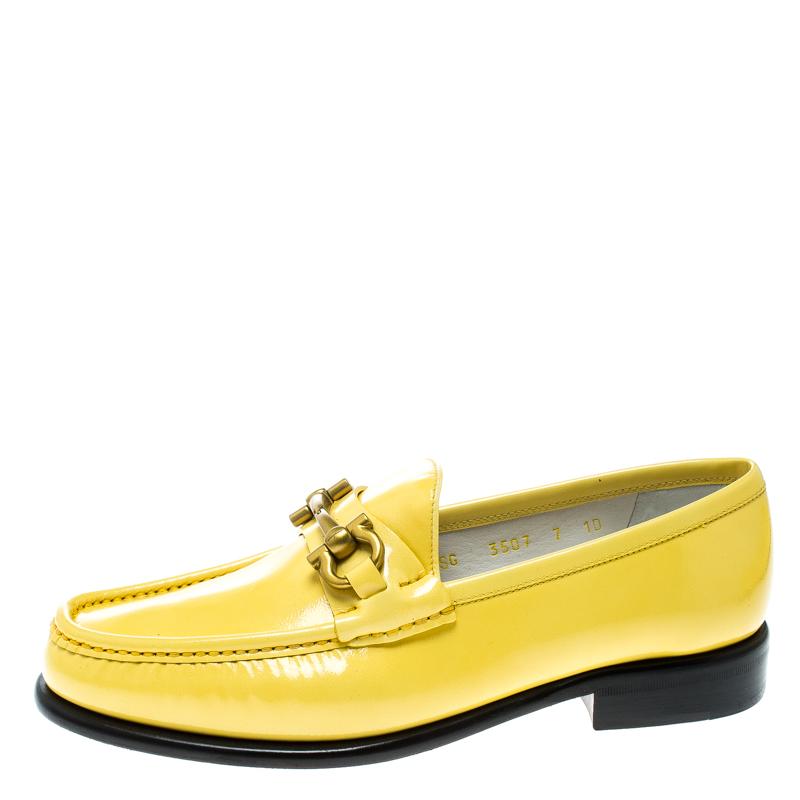 These loafers from Salvatore Ferragamo are not only high on appeal but also very skilfully made. They have been crafted from yellow patent leather in Italy and designed with beauty using neat stitching and the Gancio Bit on the uppers. The loafers