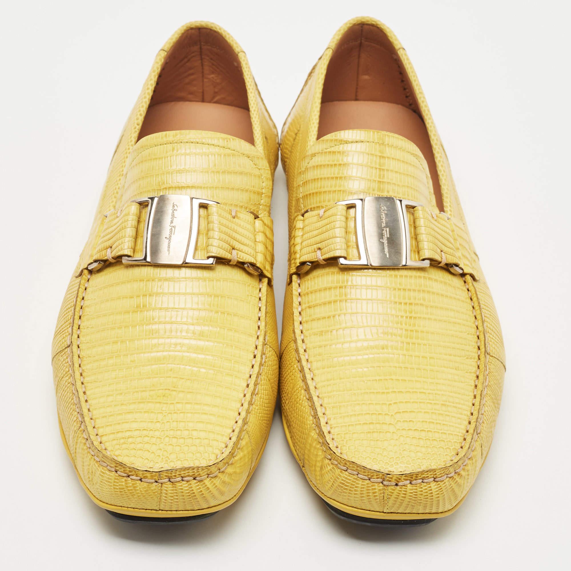 Created using exotic lizard leather, these Sardegna loafers from Salvatore Ferragamo lend a unique aspect to your footwear collection. The loafers have a yellow shade on their exterior, with silver-toned accents decorating the vamps. Embrace a new
