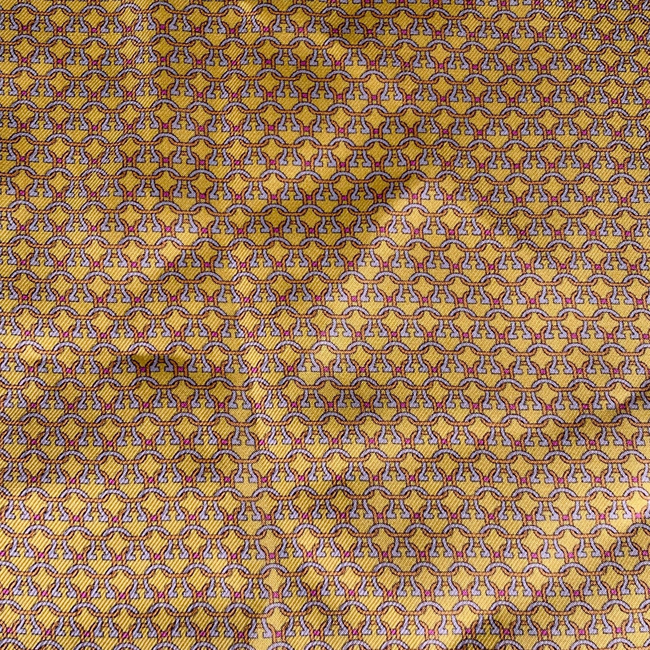 SALVATORE FERRAGAMO pocket square a yellow and white silk fabric featuring an abstract interlocking pattern and picture frame border. Made in Italy.New with Tags. 

Measurements: 
  16.5 inches  x 16.5 inches 
  
  
 
Sui Generis Reference: