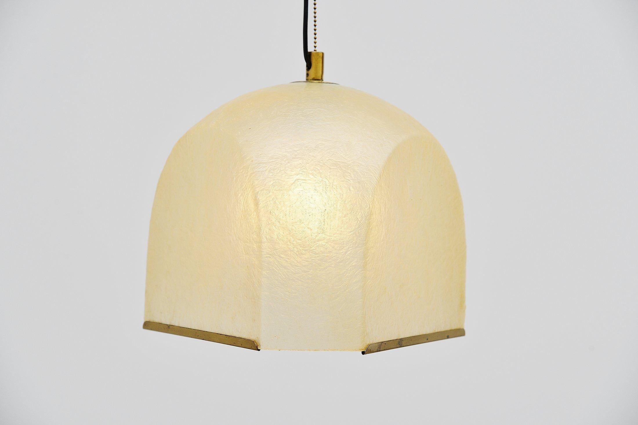 Very nice fiberglass pendant lamp designed by Salvatore Gregorietti for Lamperti, Italy 1965. This rare hanging lamp has a semi transparent fiberglass shade with brass covered rims. There is a brass chain that holds the shade and brass wall plate as