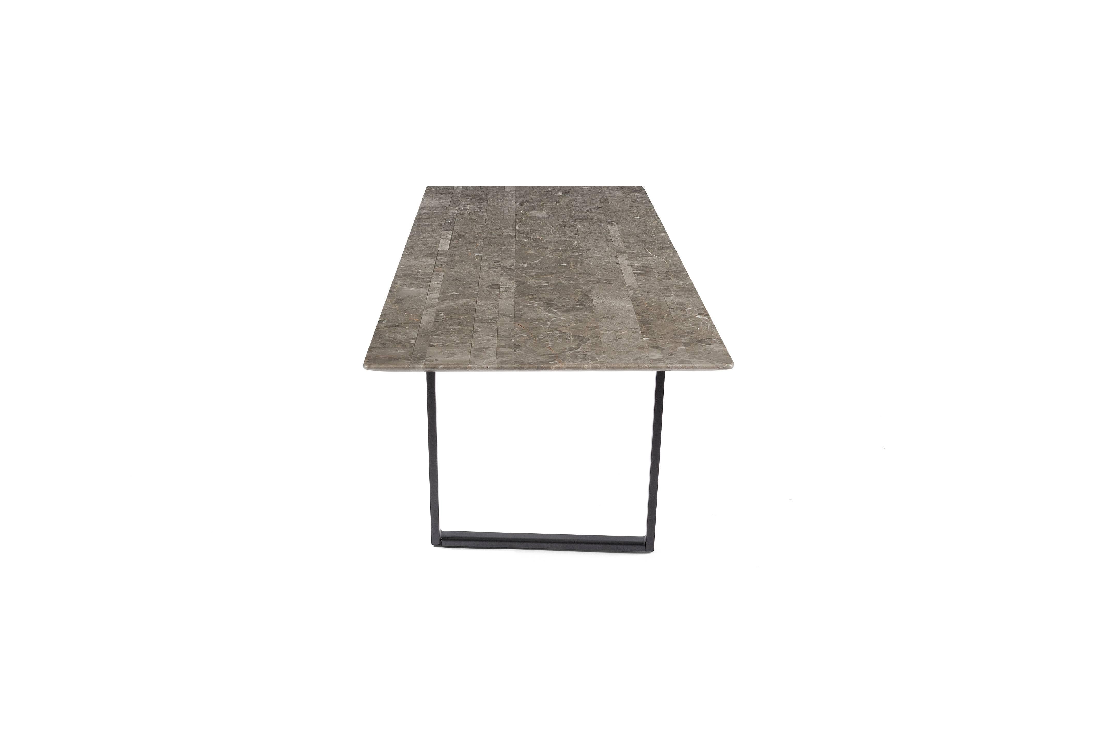 Designed by Piero Lissoni exclusively for Salvatori, Dritto combines elegant lines of Classic natural stone with a bold geometric frame crafted from iron. Its defining characteristic is the curved underside of the top, and its uber-fine edges of a