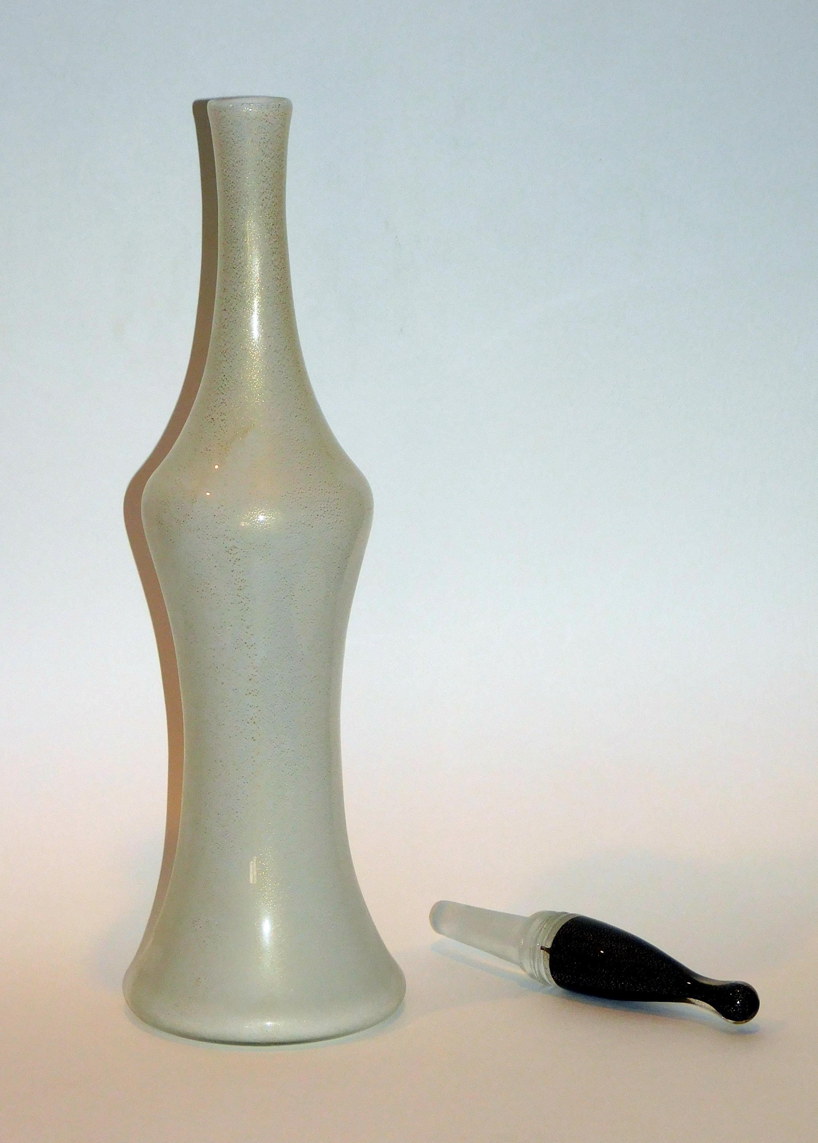 Classic Mid-Century Modern tall stoppered bottle in mint condition by Salviati & Co.
A great form. Bears the original label and the original stopper.
Stunning white with gold fleck. The stopper is black with gold fleck.
20