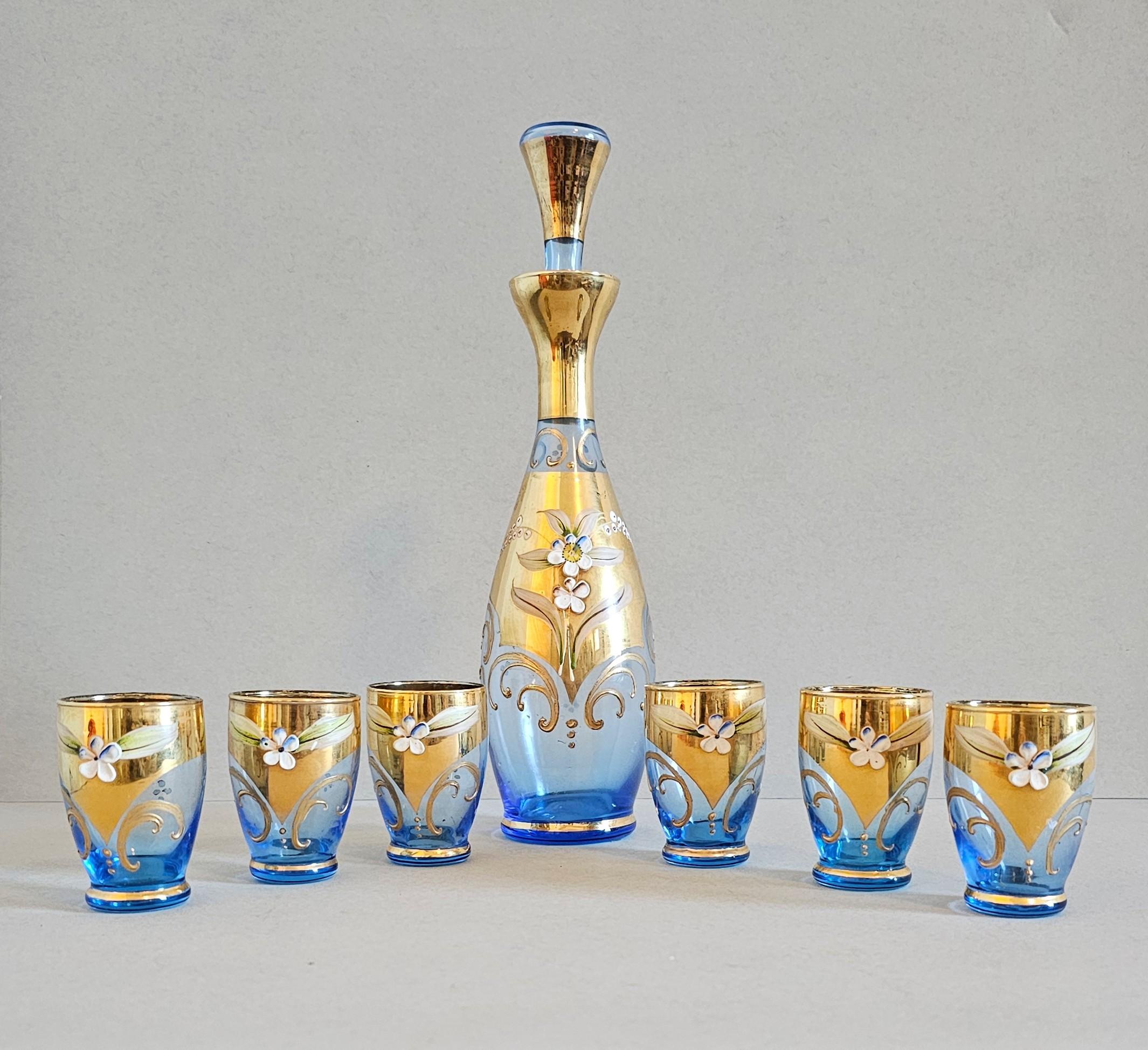 Elevate any bar cart, liquor cabinet, or barware collection with this stunning hand-blown Murano art glass liqueur set by Salviati & Co.

Hand-crafted in Venice, Italy, mid-century, featuring beautiful sky blue glass with brilliant parcel gilt trim