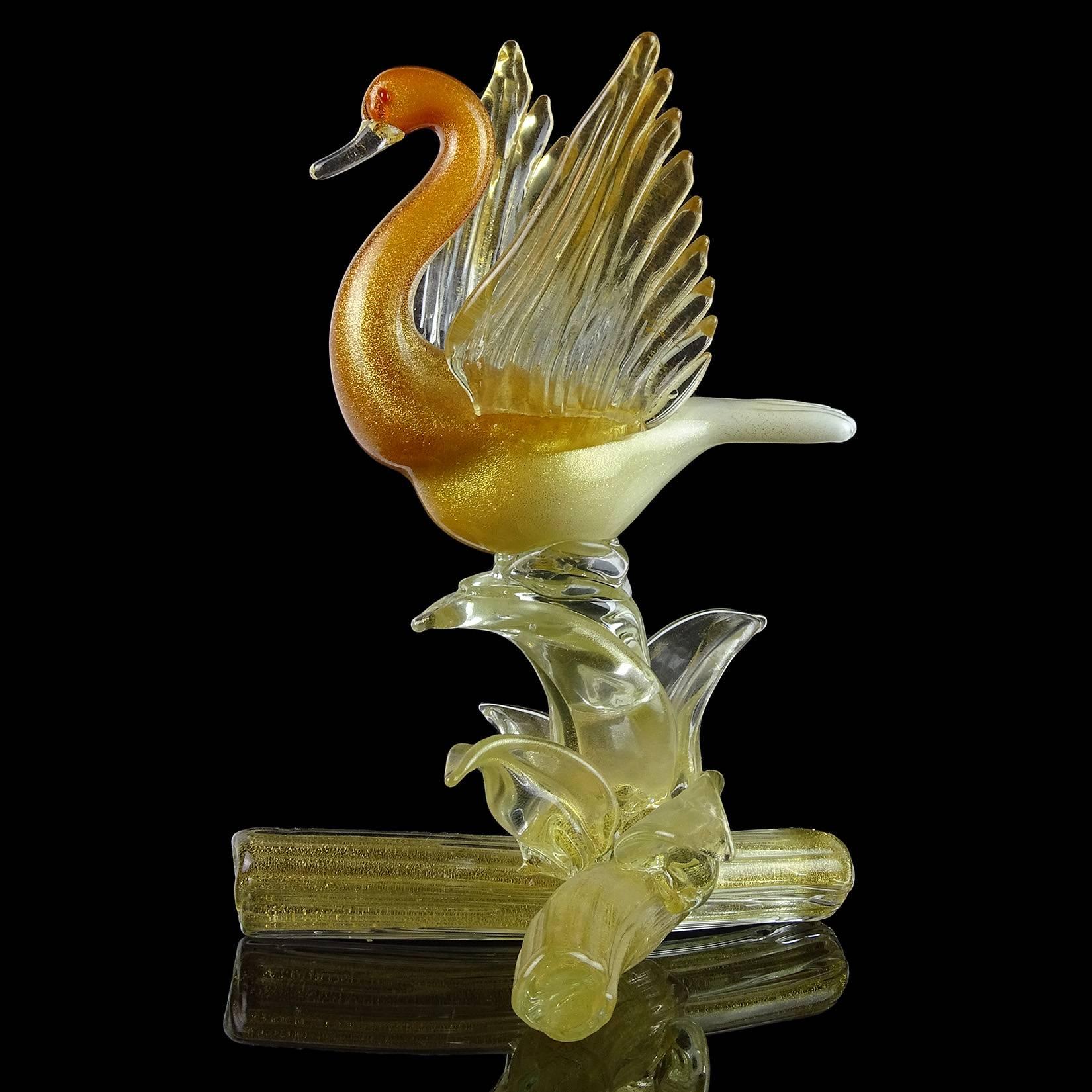 Beautiful vintage Murano hand blown orange, white, and gold flecks Italian art glass bird sculpture. Documented to the Salviati Company, with original label underneath. Profusely covered in gold leaf, with an Ombre fade in color. It stands on a