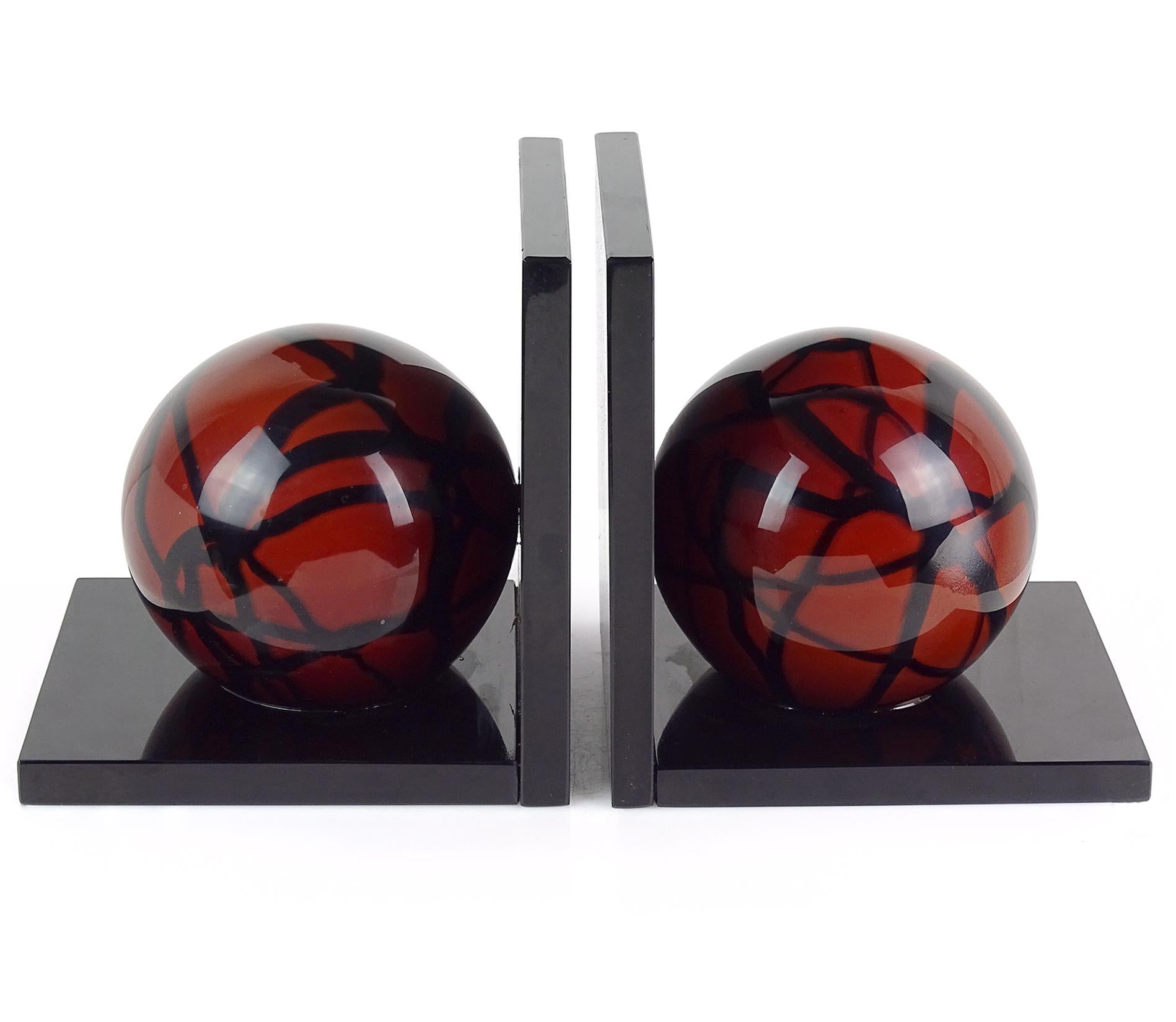 Beautiful, large and vintage Murano hand blown red ball Italian art glass sculptural bookends with black panels and squiggle decoration. Documented to the Salviati Company, with both bookends signed 